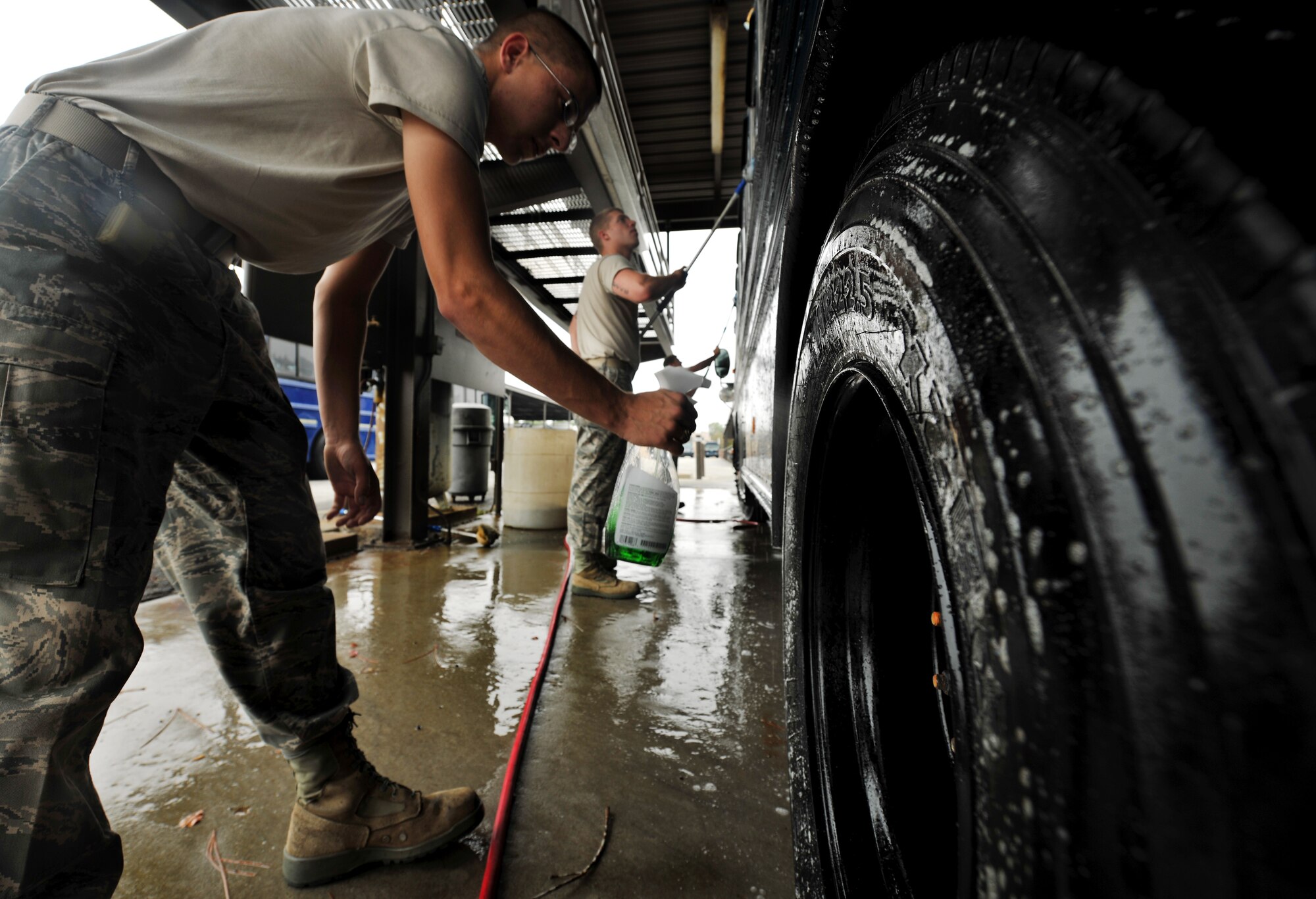 MOODY AIR FORCE BASE, Ga.-- Three Airmen from the 23rd Logistics Readiness Squadron vehicle operations flight  clean and wash down a bus used in a recent operational readiness exercise. On a regular week, Airmen from the flight inspect and wash vehicles every Tuesday, if needed. (U.S. Air Force photo/Airman 1st Class Joshua Green)(RELEASED)
