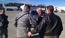 Col. Phil Fallin (center), 916th Air Refueling Wing vice commander, thanks a member of 4th Fighter Wing Security Forces after his fini-flight here on Dec. 15. (USAF photo by MSgt. Kenny Fallin, 77ARS)