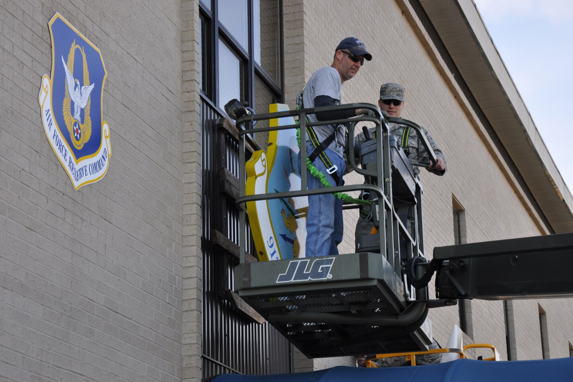 Master Sgt. Jody D. Pieper, an Air Reserve Technician with the 917th Maintenance Group and Airman First Class Nicolas Lindner, a Regular Air Force Total Force Enterprise Airman from the 2nd Maintenance Squadron, assigned to the 917th Wing, remove the 917th Wing Headquarters sign at Barksdale Air Force Base, La., Dec. 10, 2010. Both Airmen work in the 917th MXS Aerospace Ground Equipment shop at Barksdale AFB. A new sign for the 307th Bomb Wing will replace the 917th Wing sign to reflect the changes coming to the Reserve Wing at Barksdale. The 917th Wing will be deactivated, and the 307th Bomb Wing reactivated in ceremonies at Hoban Hall on Barksdale, Jan. 8, 2011. In addition to those changes, the 917th Operations Group will be re-designated as the 917th Fighter Group in the same ceremonies. Although the equipment and personnel assigned to the 917 FG will remain at Barksdale, command and control for the unit will fall under the 442nd Fighter Wing at Whiteman Air Force Base, Mo. (U.S. Air Force photo /Tech. Sgt. Jeff Walston)