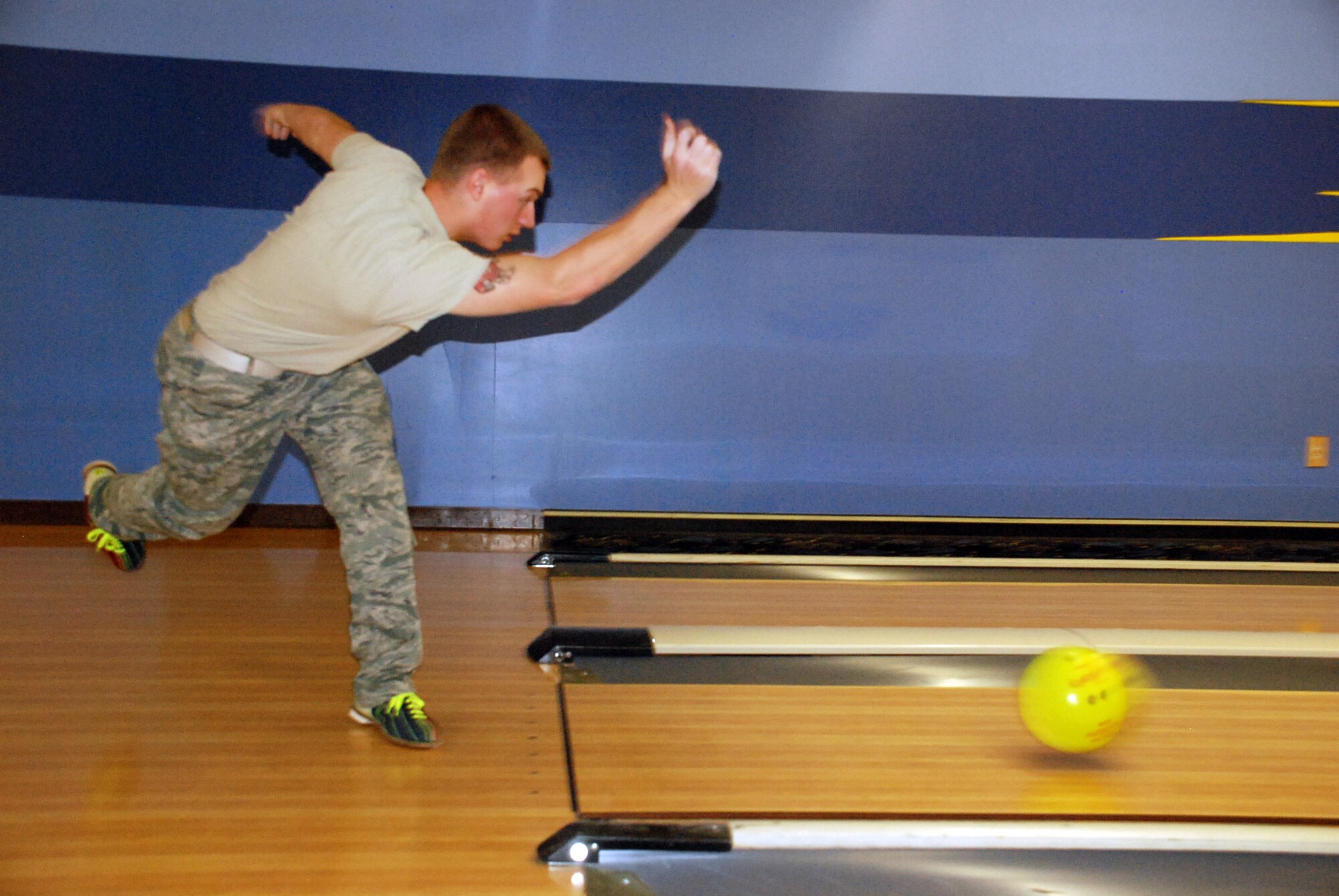 Amn. Alex Badger, 90th Civil Engineers Squadron, throws the ball down the lane on en route to finishing his game with a 172. Airman Badger and a group of his co-workers participated in the fund-raiser for the annual awards during their lunch break Dec. 10. (U.S. Air Force photo by Airman 1st Class Dan Gage)