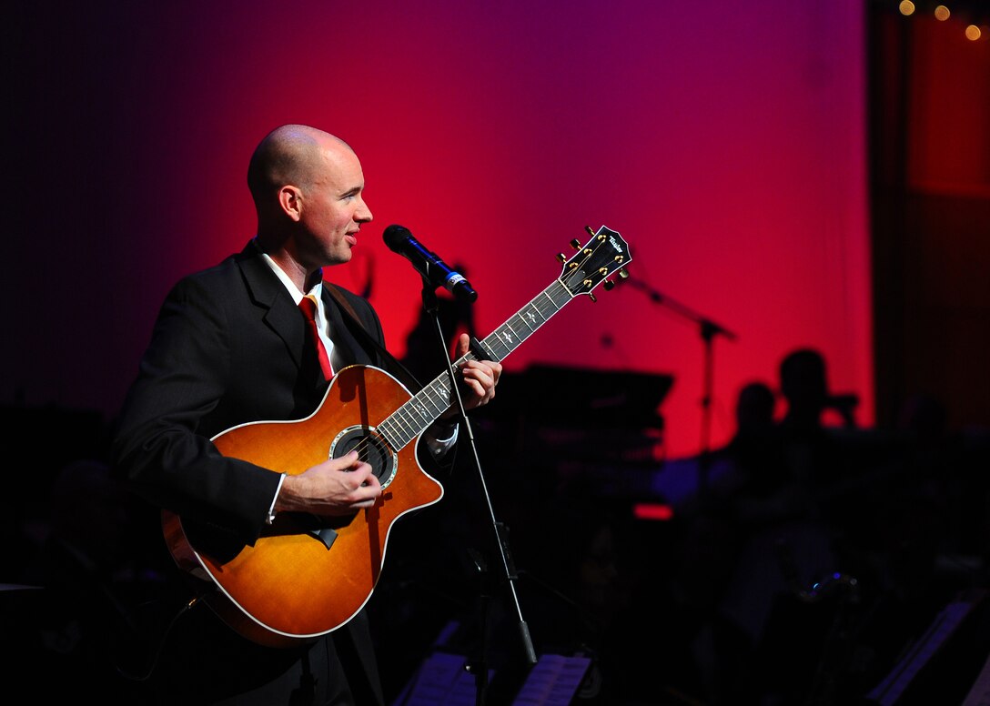 Staff Sgt. Jonathan Biccum performs on guitar with Winds of Freedom in an exciting rendition of 'We Three Kings' during the USAF Heartland of America Band's annual holiday concert series.