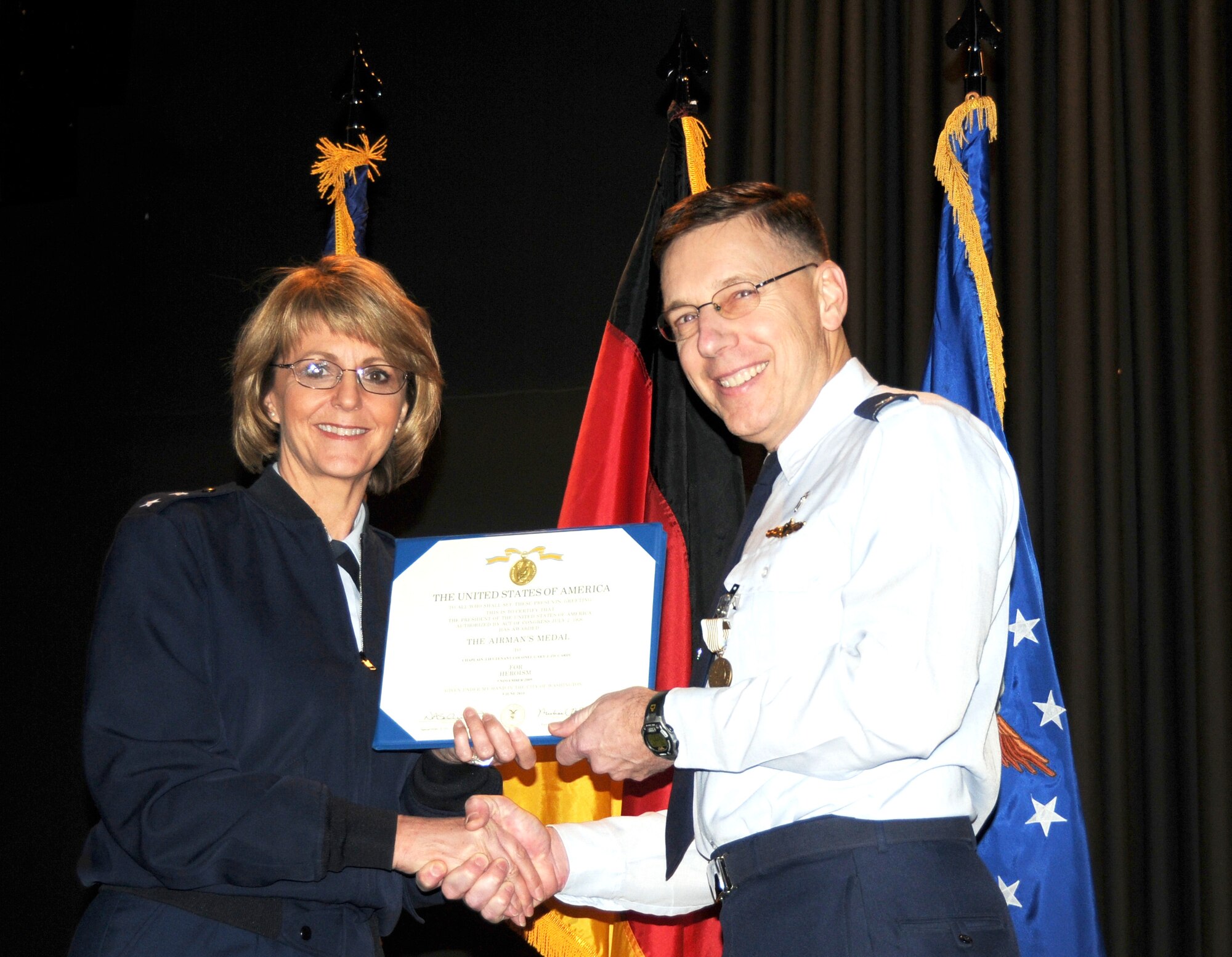RAMSTEIN AIR BASE, Germany – 17th Air Force Commander Maj. Gen. Margaret Woodward presents the Airman’s Medal to 17th’s Command Chaplain (Lt. Col.) Gary Ziccardi Nov. 29 at a commander’s call. Zicarrdi was awarded the medal for rescuing a swimmer that was drowning in November, 2009. (US Air Force photo by Master Sgt. Jim Fisher) 