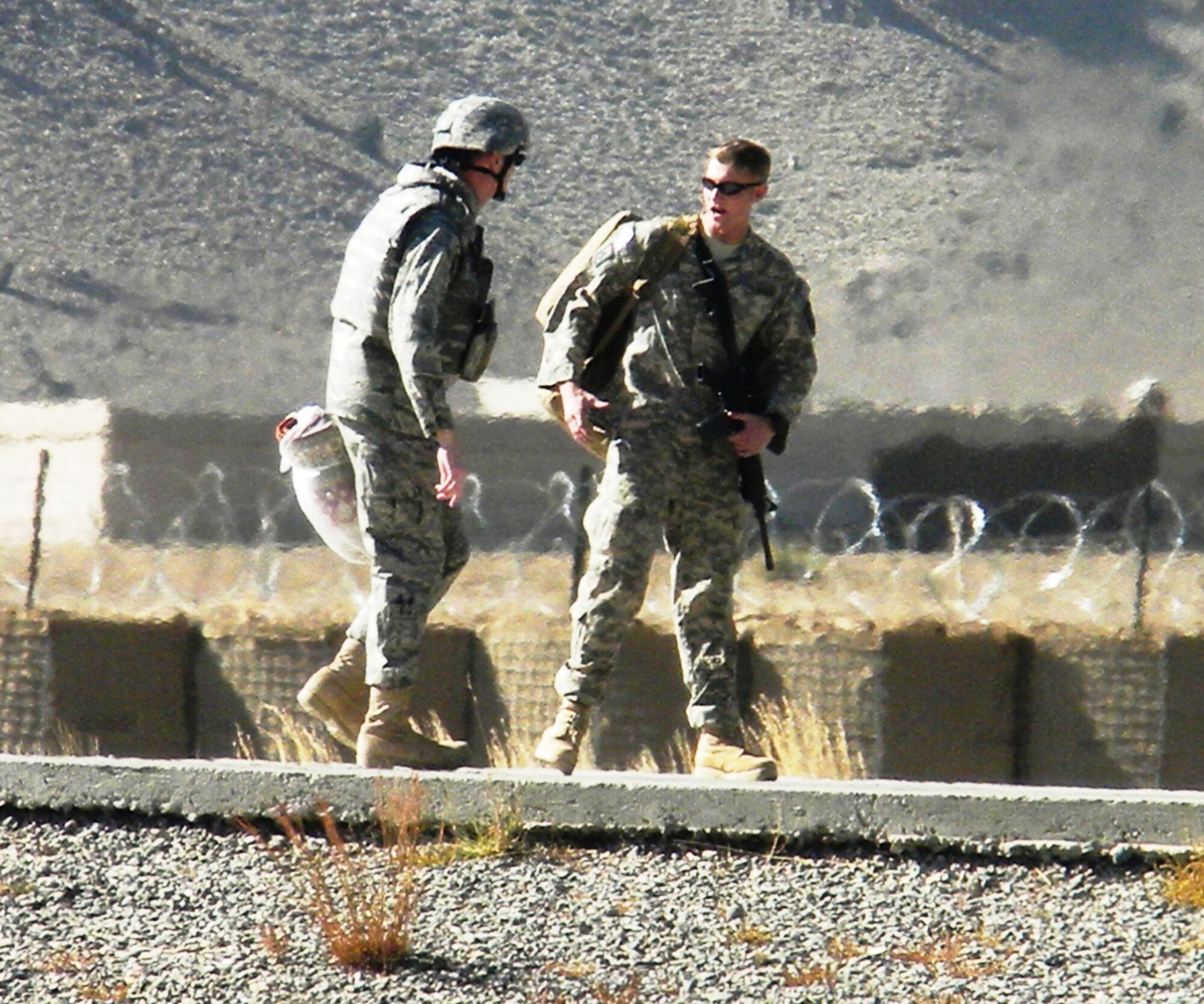 AFGHANISTAN -- Newly promoted Army 1st Lt. Jonathan Wood says goodbye to his father, Col. Paul Wood, Nov. 26, at the Camp Clark landing zone. Colonel Wood is the director of logistics with Air Forces Central A-4 in Southwest Asia. (Courtesy photo)