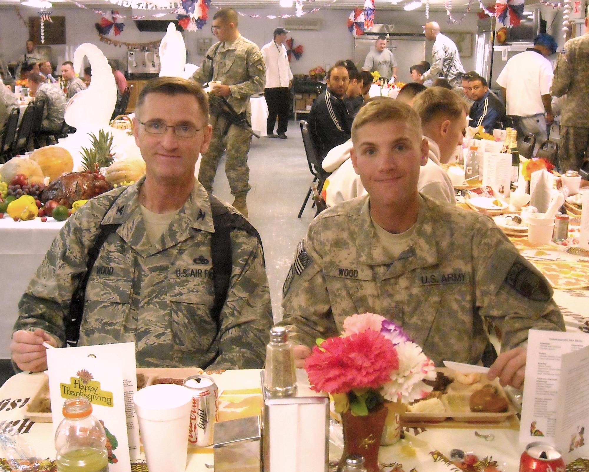 AFGHANISTAN -- Then-2nd Lt. Jonathan Wood celebrates Thanksgiving with his father, Air Force Col. Paul Wood, at Camp Clark in Afghanistan. Later that night, Jonathan Wood was promoted by his father. The junior Wood is with the Regional Support Command-East, NATO Training Mission-Afghanistan. (Courtesy photo)