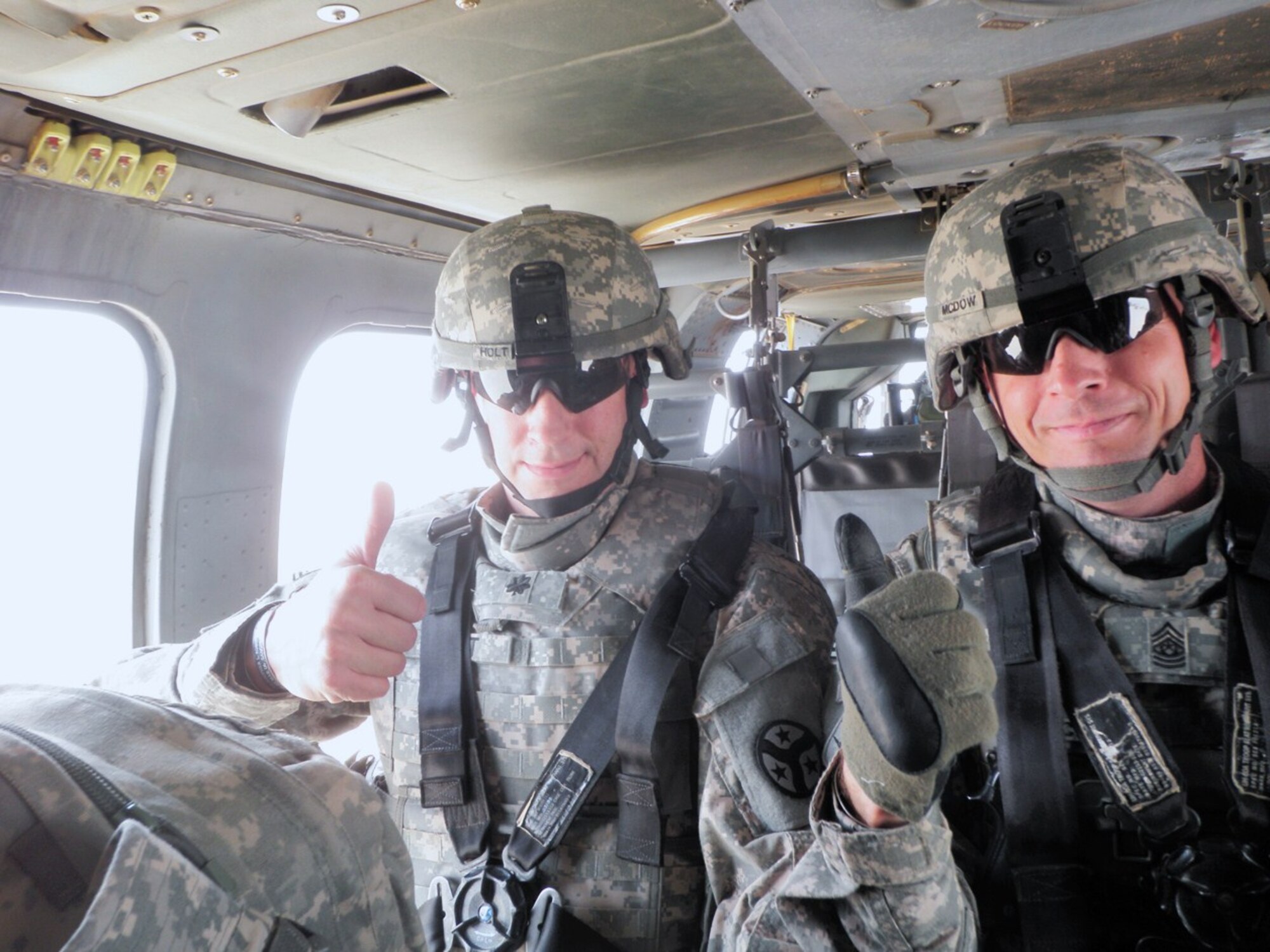 Lt. Col. Warner Holt (L), commander, and command Sgt. Maj. Tracy McDow of the Regimental Fires Squadron, 278th Armored Cavalry Regiment prepare to take off in a Blackhawk helicopter from northern Iraq, June 10, 2010. (Photo provided)