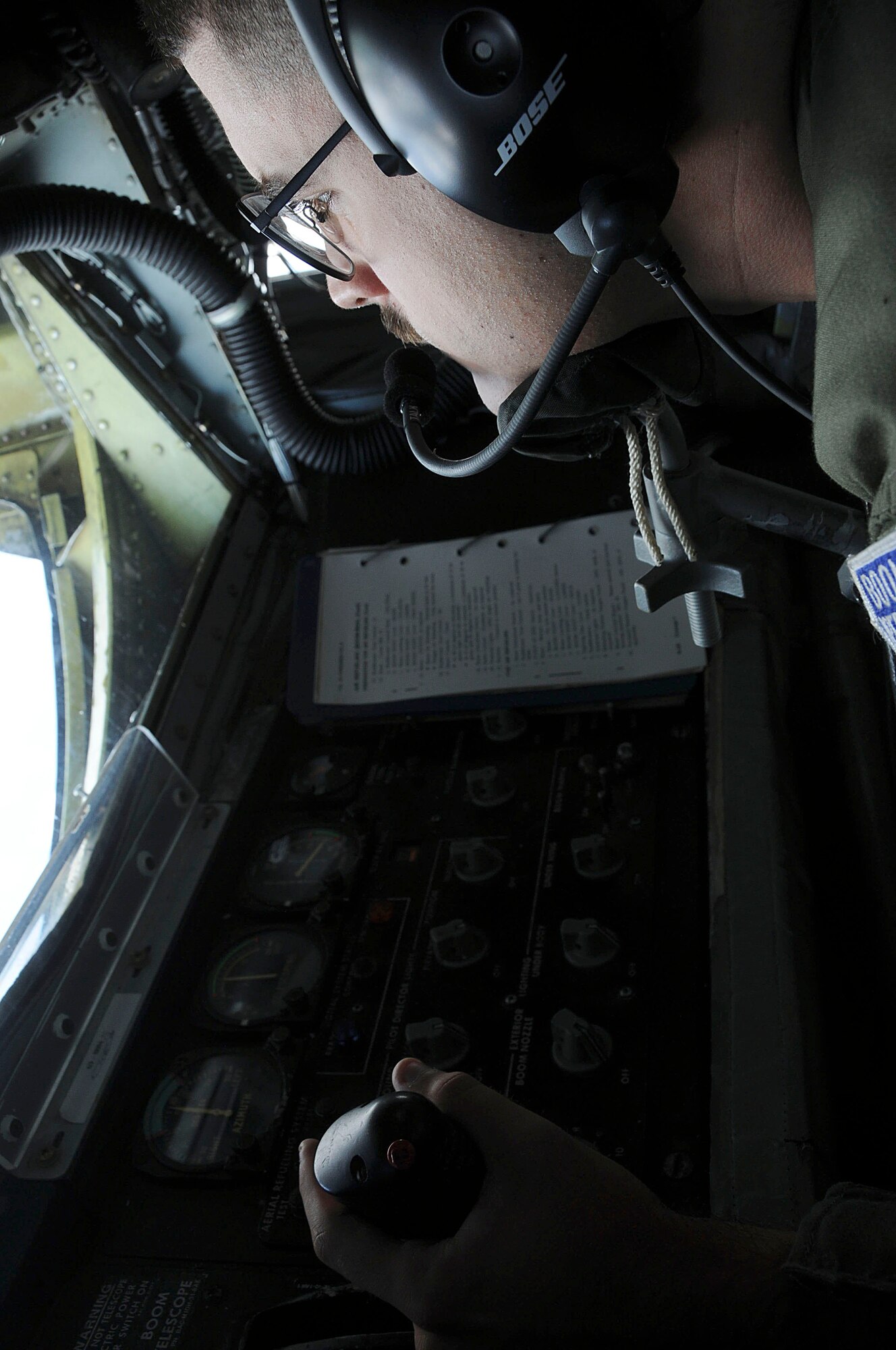 Senior Airman Bruce Freed, 909th Air Refueling Squadron journeyman boom operator, controls the boom during the joint refueling training between the 909th Refueling Squadron and Japan Air Self Defense Forces, Dec. 17. This training improved bilateral relationships between the 18th Wing and JASDF members. (U.S. Air Force photo/Staff Sgt. Darnell T. Cannady)