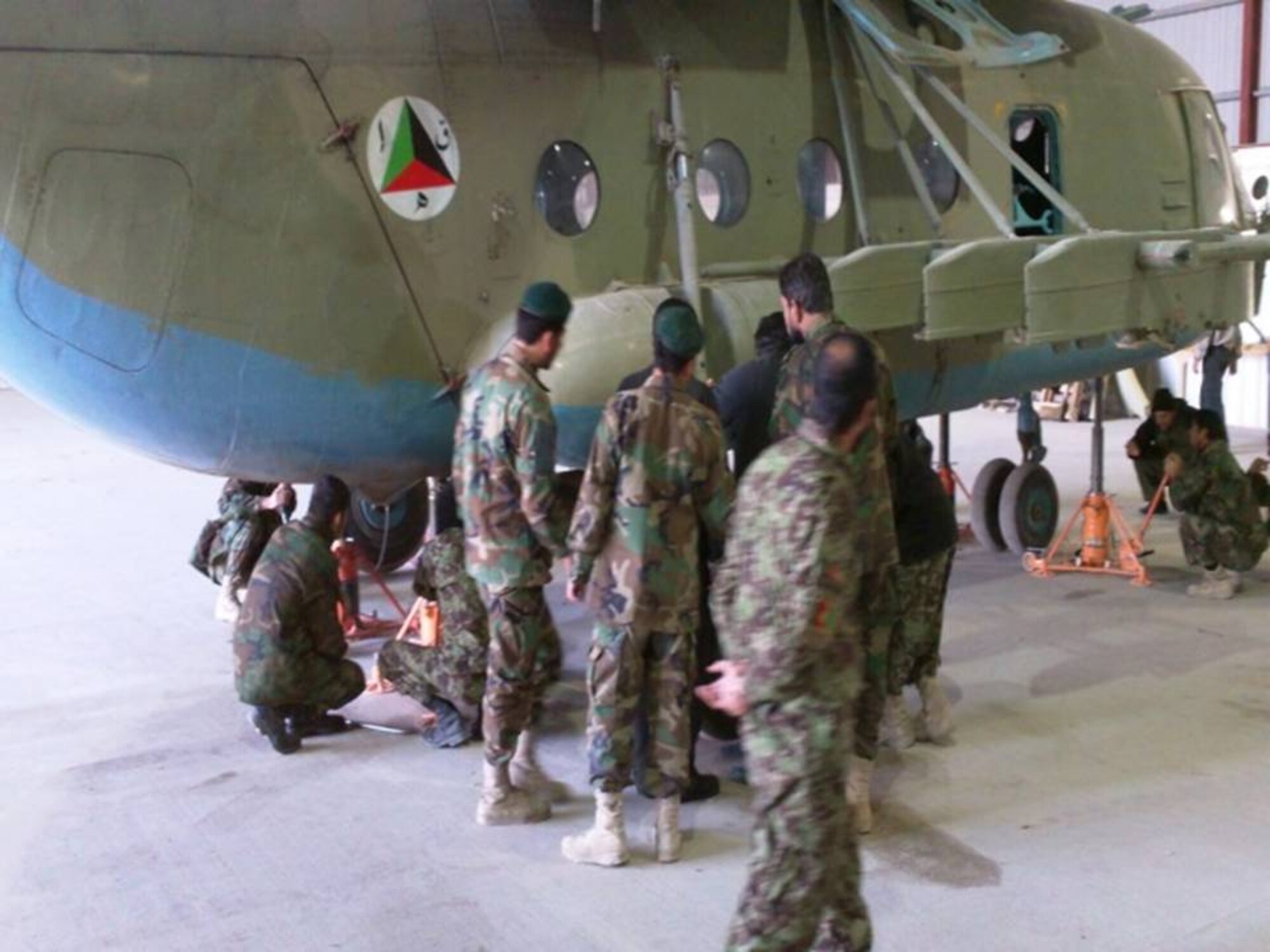 Kandahar Air Wing personnel and NATO Air Training Command-Afghanistan complete the first 200 hour maintenance phase inspection on the Mi-17/572 helicopter. (Photo by U.S. Air Force/Released).