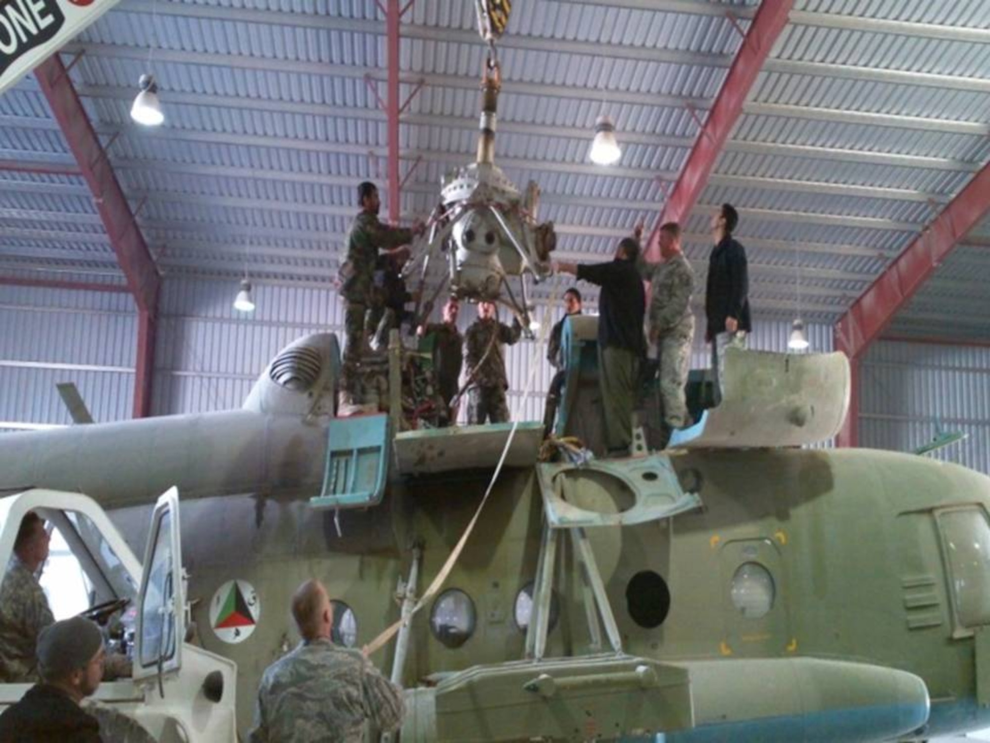 Kandahar Air Wing personnel and NATO Air Training Command-Afghanistan complete the first 200 hour maintenance phase inspection on the Mi-17/572 helicopter. (Photo by U.S. Air Force/Released).