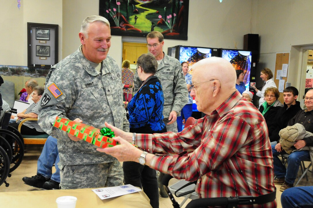 U.S. Army Sgt. Jerry Schmidt hands out Christmas presents at a North