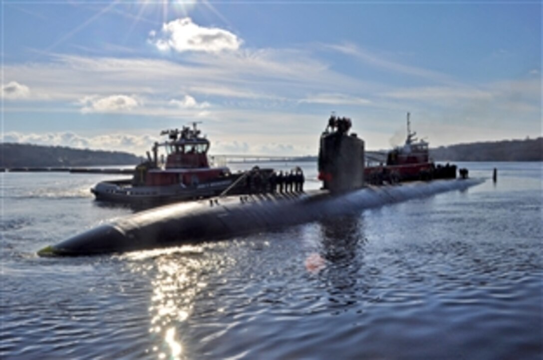 Two tugboats push the Los Angeles-class submarine USS Alexandria into port at Naval Submarine Base New London, Conn., Dec. 18, 2010. Alexandria is returning from a scheduled six-month deployment. 