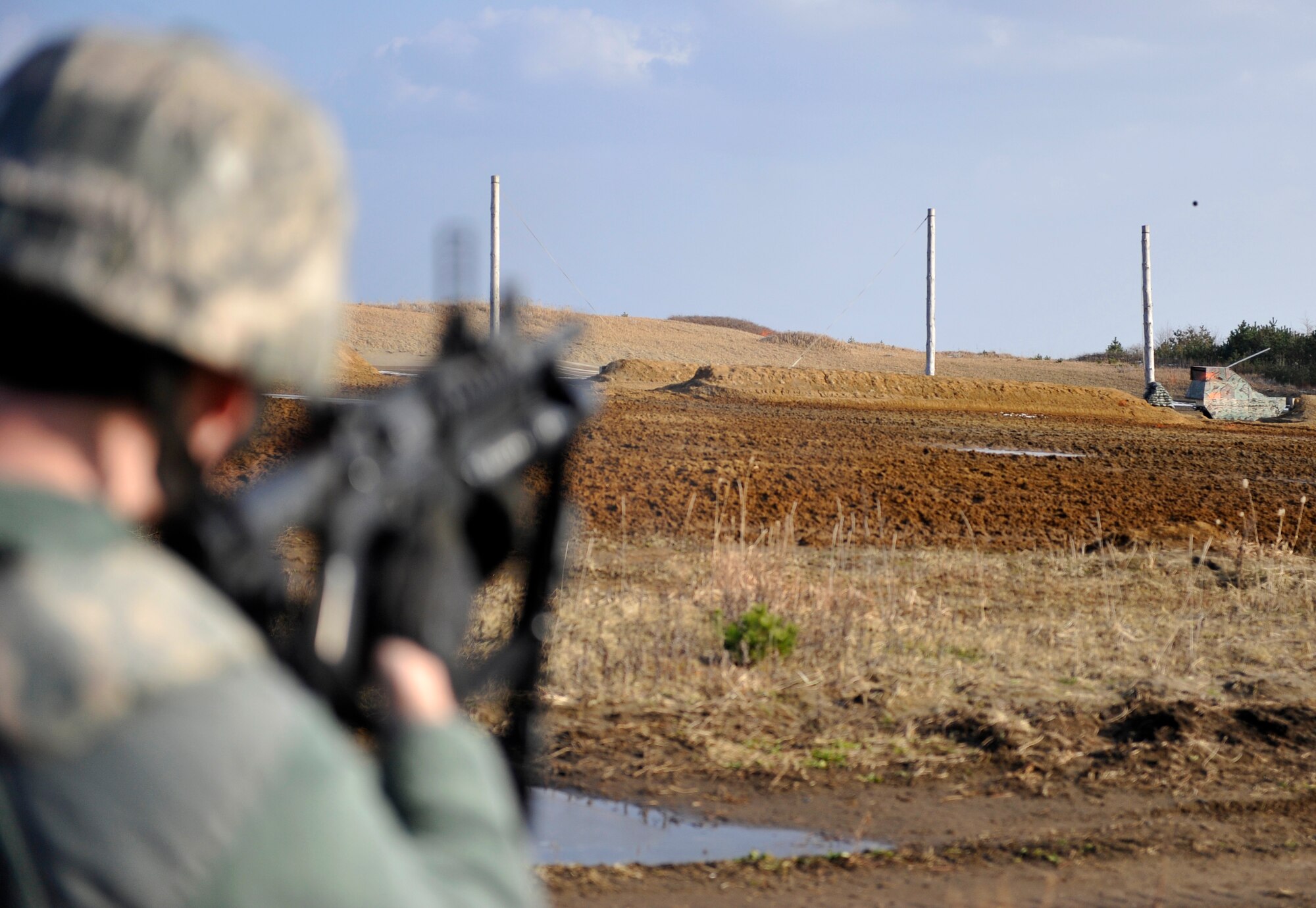 U.S. Air Force Airman 1st Class Jarrod Chambers, 35th Security Forces Squadron patrolman, fires an M203 grenade launcher during training Dec. 21, 2010 at Draughon Range, Misawa Air Base, Japan. During the training, students fired M781 practice rounds, which release an orange chalk upon impact. (U.S. Air Force photo by Staff Sgt. Chad C. Strohmeyer)