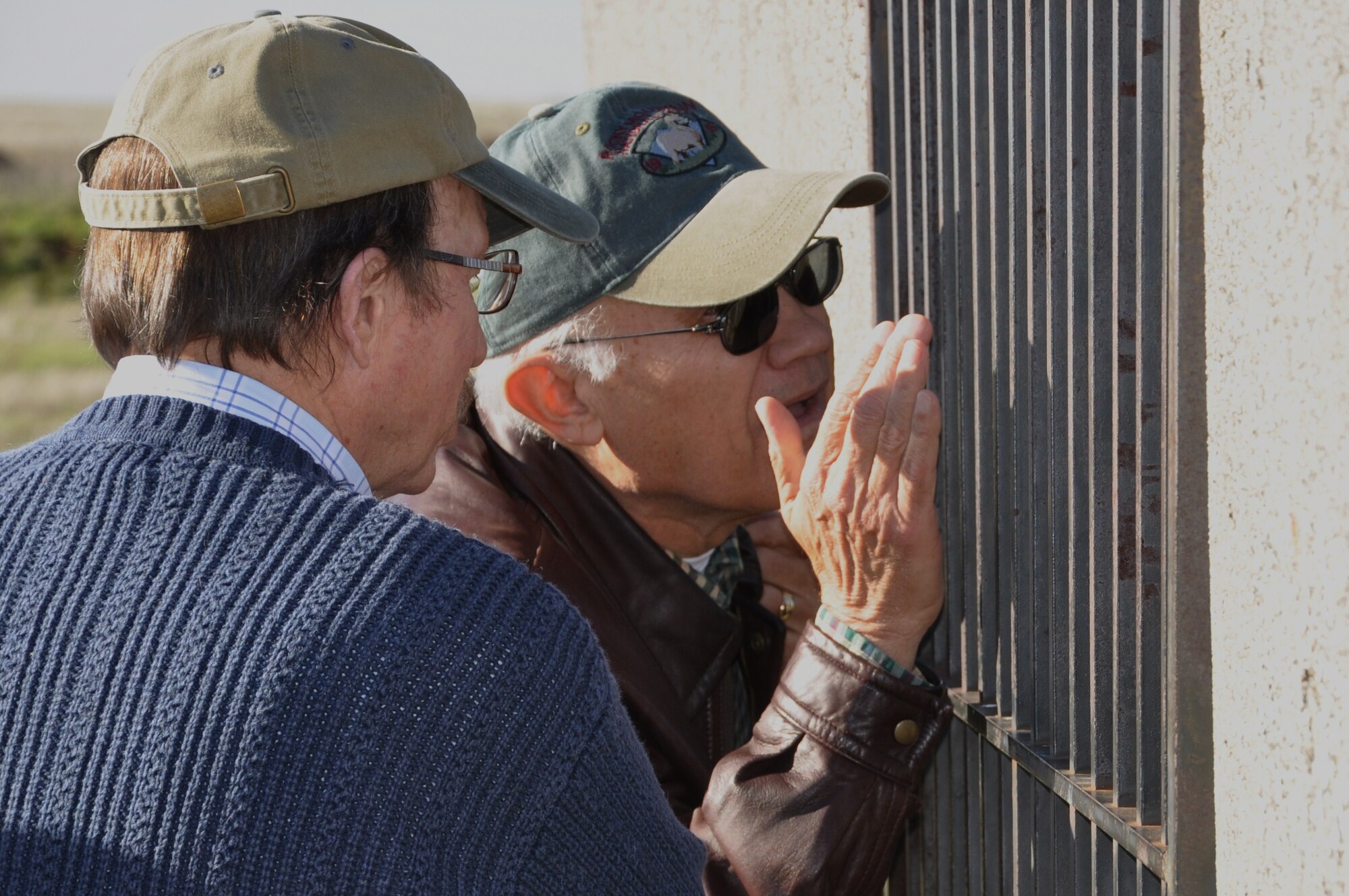 Curious visitors peer through the bars of a cell at the World War II-era POW Museum on Beale Air Force Base, Dec 16, 2010.  The men were members of a group of local residents who toured the 940th Wing's Operations Group to learn about the organization's Reserve mission. (U.S. Air Force photo/Dana Lineback) 