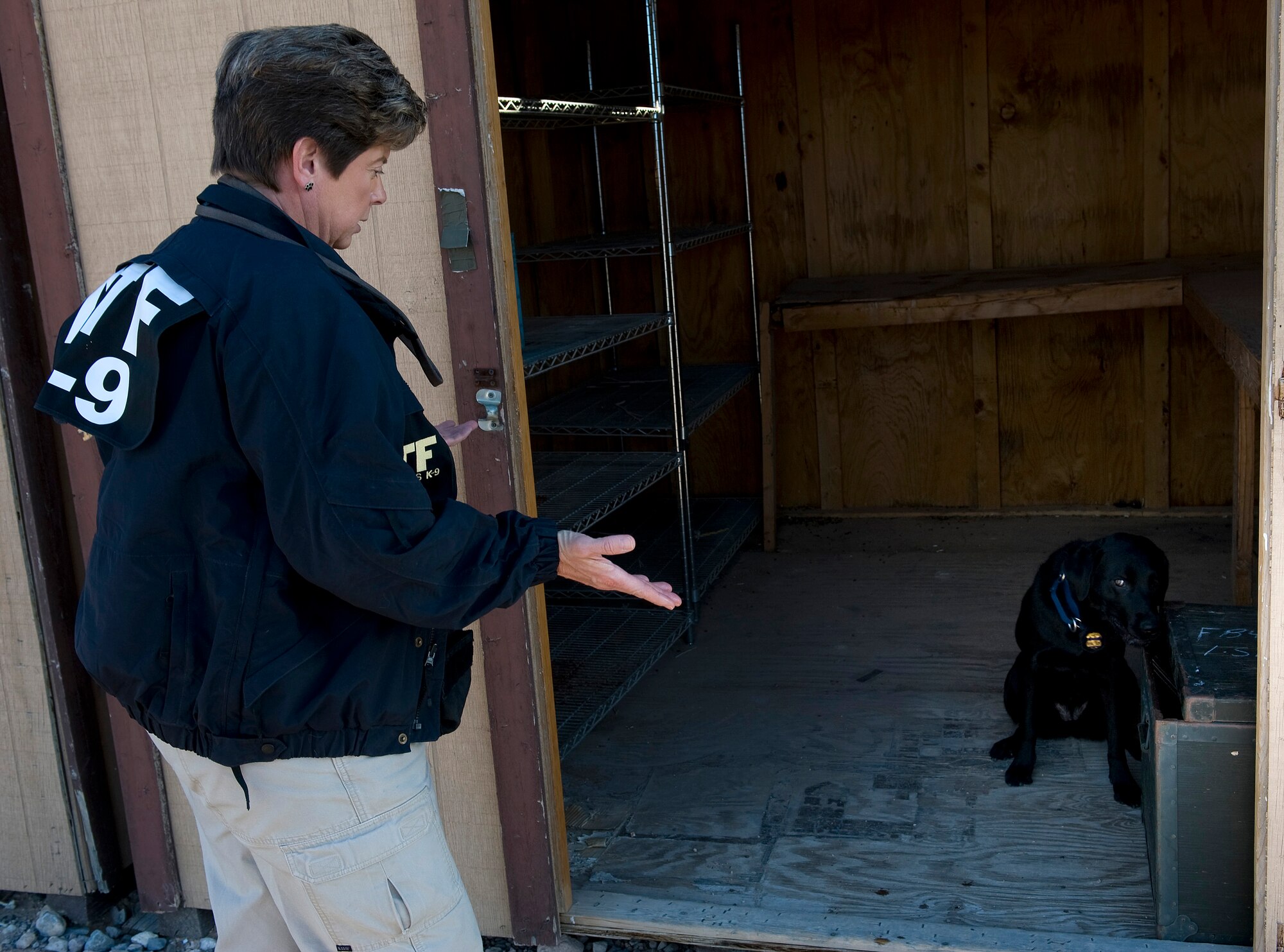 NELLIS AIR FORCE BASE, Nev.-- Lauren Marakas, senior special agent canine handler from the Bureau of Alcohol, Tobacco, Firearms, and Explosives, questions Ruthie, an explosives detection canine, to find where explosives are hidden during a joint explosive detection training exercise Dec. 16. Military working dog handlers from the 99th Security Forces Squadron worked with 25 canine teams from the Las Vegas area.(U.S. Air Force photo by Senior Airman Brett Clashman)