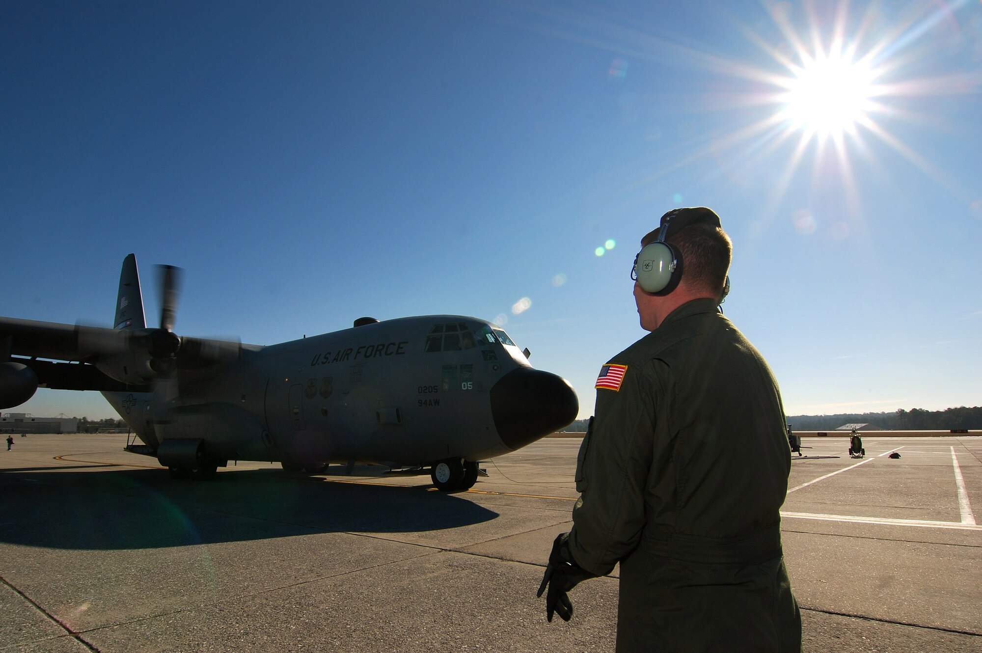Senior Airman Brett Grove a loadmaster with the 700th Airlift Squadron communicates with the rest of the C-130H2 Hercules aircrew as he monitors the start of the number three engine at Dobbins Air Reserve Base, Ga., Dec 20.   The Hercules belongs to the 94th Airlift Wing at Dobbins.   (U.S. Air Force photo/ Brad Fallin)