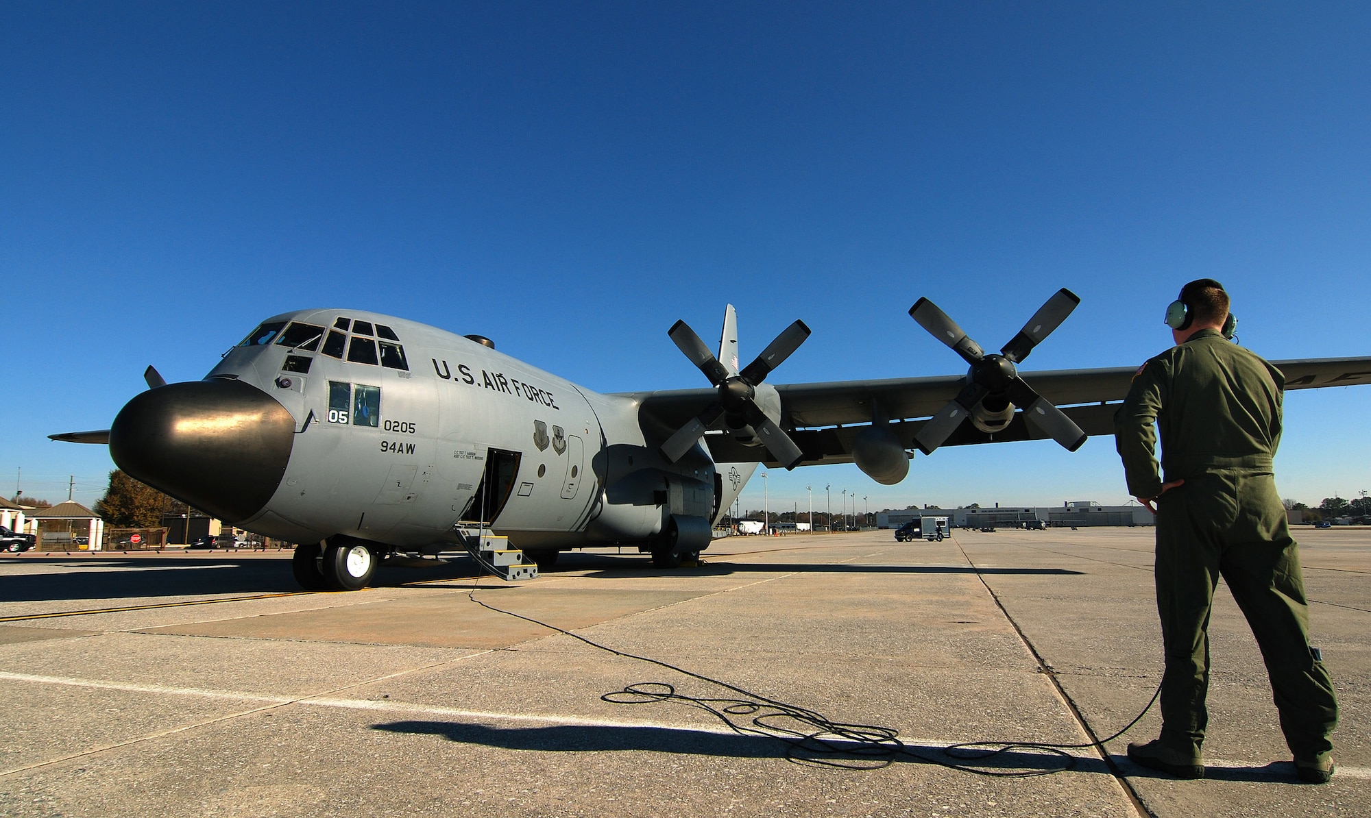 Senior Airman Brett Grove a loadmaster with the 700th Airlift Squadron communicates with the rest of the C-130H2 Hercules aircrew just prior to engines start at Dobbins Air Reserve Base, Ga., Dec 20.  The Hercules belongs to the 94th Airlift Wing at Dobbins.  (U.S. Air Force photo/ Brad Fallin)