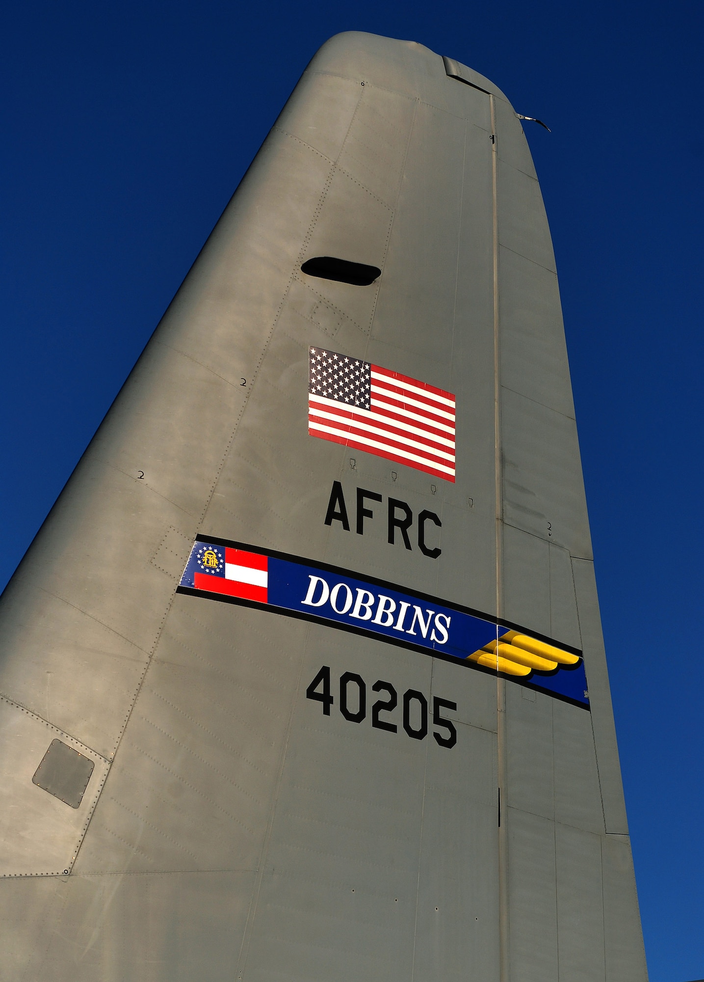 The tail flash on the vertical stabilizer of a Dobbins Air Reserve Base C-130H2 Hercules, Dec 20.  The top of the tail is 38 feet, 10 inches above the ground on the 94th Airlift Wing aircraft.  (U.S. Air Force photo/ Brad Fallin)