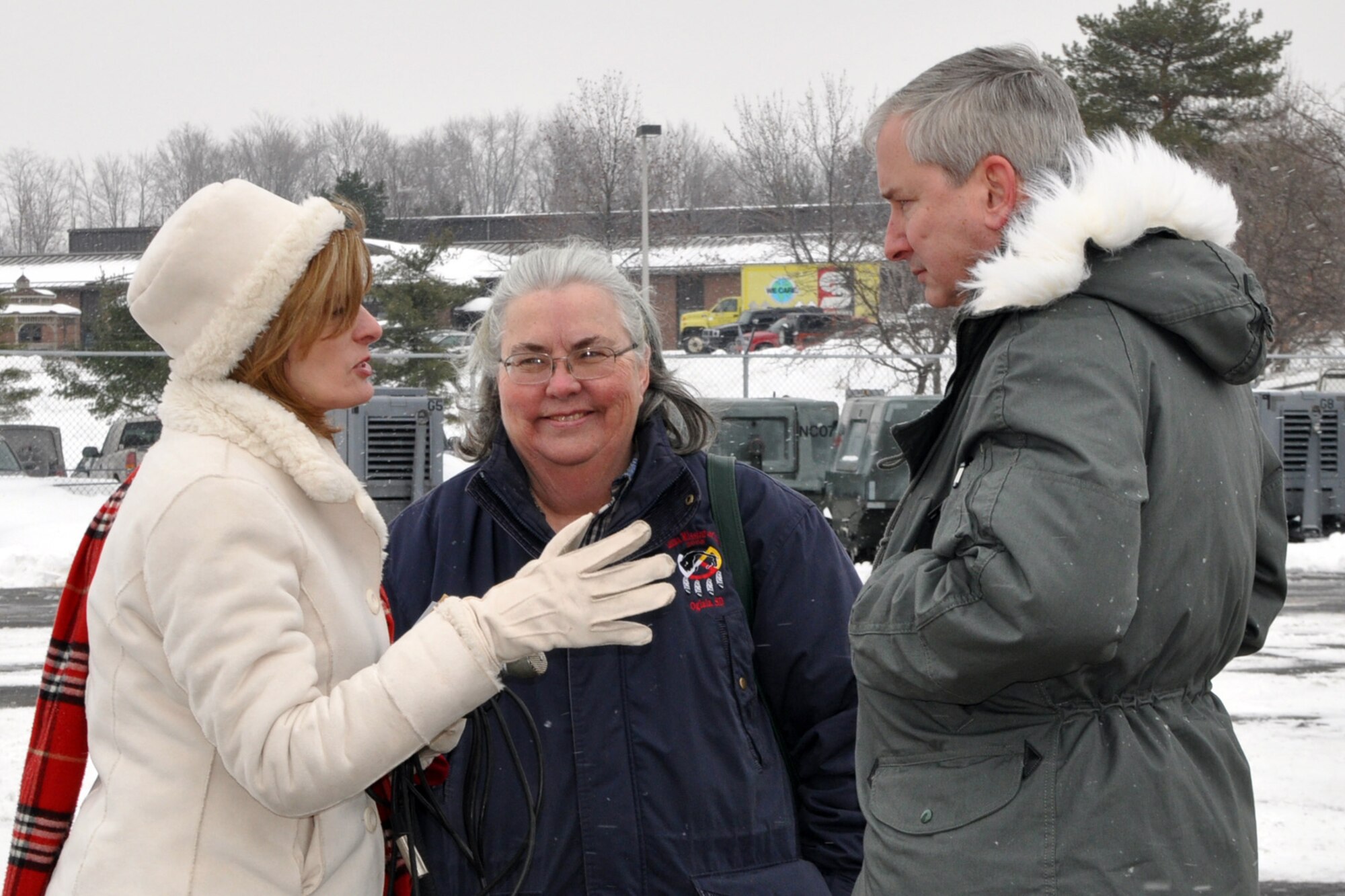 YOUNGSTOWN AIR RESERVE STATION, Ohio -- Air Force Reserve Col. Fritz Linsenmeyer (left), commander of the 910th Airlift Wing, based here, talks with Peggy Sinkovich (right), a reporter from local ABC affiliate, WYTV, and Kathleen Price (center), founder and director of Austinown, Ohio-based "Mission of Love" on the YARS flightline here, Dec. 17. They are discussing the effort to transport 47,500 pounds of humanitarian cargo collected by "Mission of Love" for residents in the communities of Santa Rita, Yora ~ Honduras affected by flooding and mudslides in hopes the aid will brighten their Christmas and holiday season. The cargo will be loaded aboard KC-10 cargo assigned to the 514th Air Mobility Wing, based at McGuire Air Force Base, NJ. Air Force Reservists from the 514th will transport the humanitarian aid to the east coast where it will then be flown to its ultimate destination in Central America. Ms. Price's non-profit organization provides humanitarian aid to those in need worldwide, especially children. The group is working with the U.S. Air Force Reserve through the Denton Program, which allows private U.S. citizens and organizations to use space available on U.S. military cargo planes to transport humanitarian goods, such as clothing, food, medical and educational supplies, agricultural equipment and vehicles, to countries in need. The program is jointly administered by a government agency known as USAID, the Department of State (DOS), and the Department of Defense (DOD). U.S. Air Force photo by Master Sgt. Bob Barko Jr.