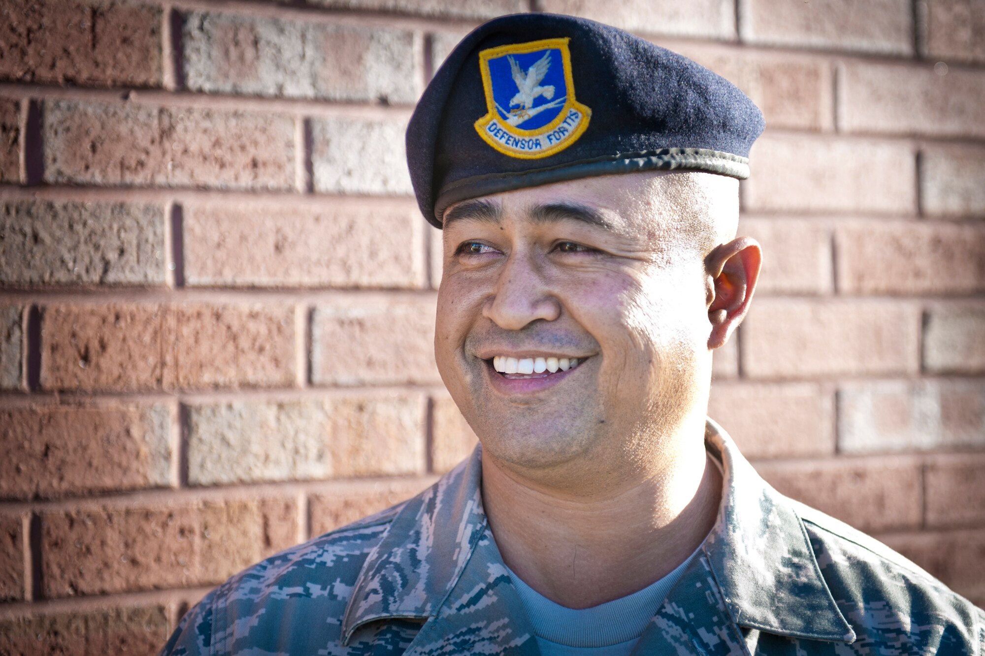 Chief Master Sgt. Joseph Pritchard takes time out of his work day to crack a smile after being interviewed Nov. 11, 2010. Chief Pritchard has been in the Air Force for more than 22 years, but said he still has a lot of knowledge to gather and pass on. He has had a passion for security forces since childhood. Chief Pritchard is the 23rd Security Forces Squadron security forces manager. (U.S. Air Force photo/Senior Airman Jamal D. Sutter)