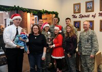 MINOT AIR FORCE BASE, N.D. – Col. Fred Stoss, 91st Missile Wing commander, poses with members of the 91st Maintenance Group as they receive the travelling trophy for best decorated section here Dec. 17. The section was decorated for the 91st MW’s annual Holiday Hallway Party and featured Santa’s workshop, which included a sleeping room for elves, a stable and the jolly man himself, Santa Claus. (U.S. Air Force photo / Airman First Class Aaron-Forrest Wainwright) 