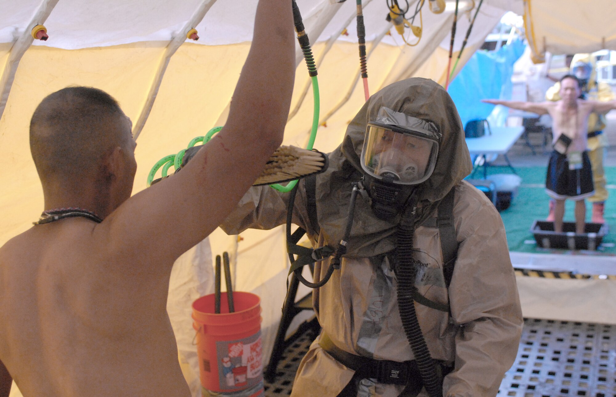 Hawaii National Guardsmen assist "victims" of a simulated dirty bomb detonation Dec. 16, 2010, at Bellows Air Force Station, Hawaii, during a homeland defense response validation exercise. (U.S. Air Force photo/Staff Sgt. Carolyn Viss)