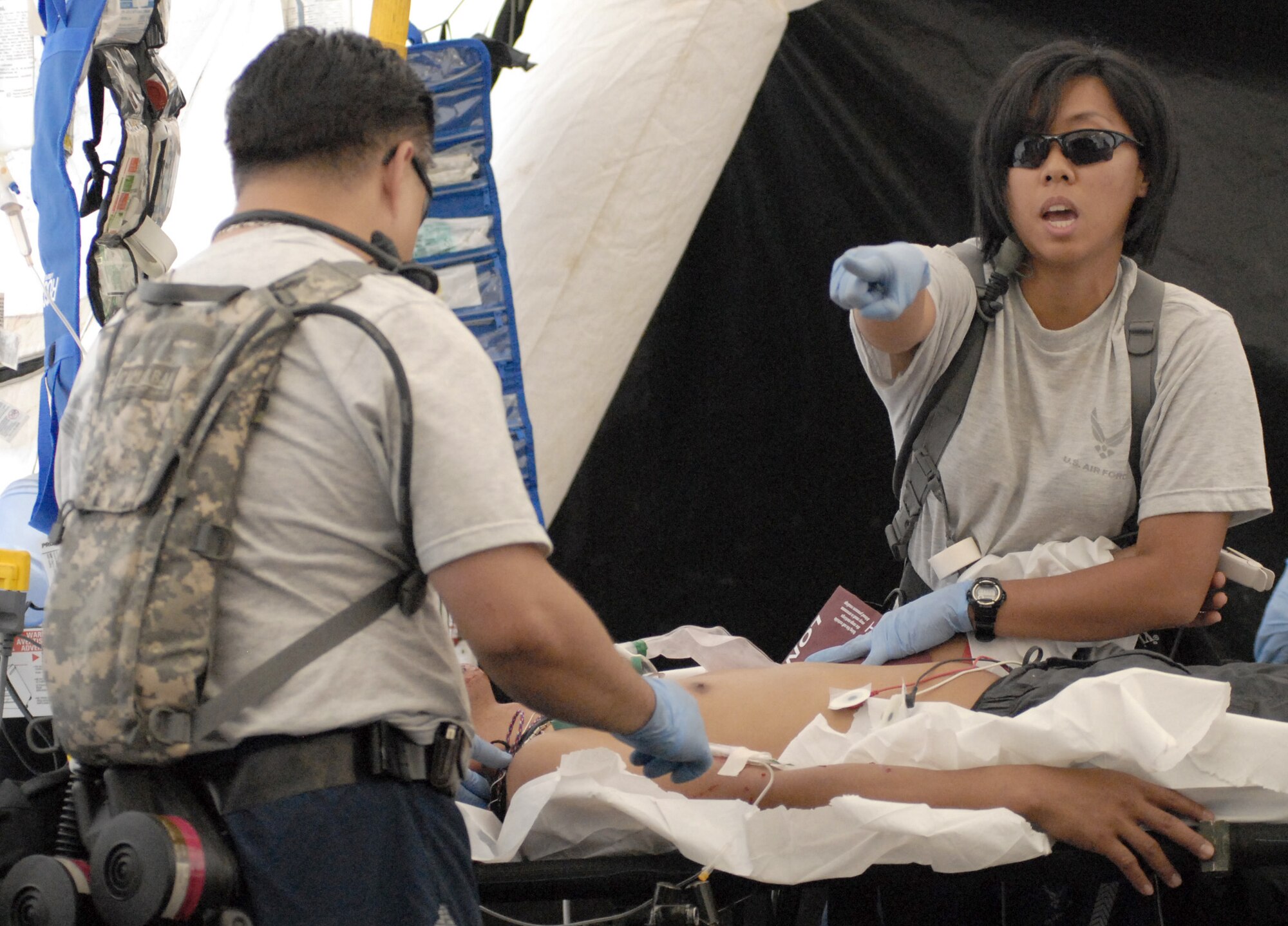 Airmen from the Hawaii Air National Guard's 154th Medical Group assist "victims" of a simulated dirty bomb detonation Dec. 16, 2010, at Bellows Air Force Station, Hawaii, during a homeland defense response validation exercise. (U.S. Air Force photo/Staff Sgt. Carolyn Viss)