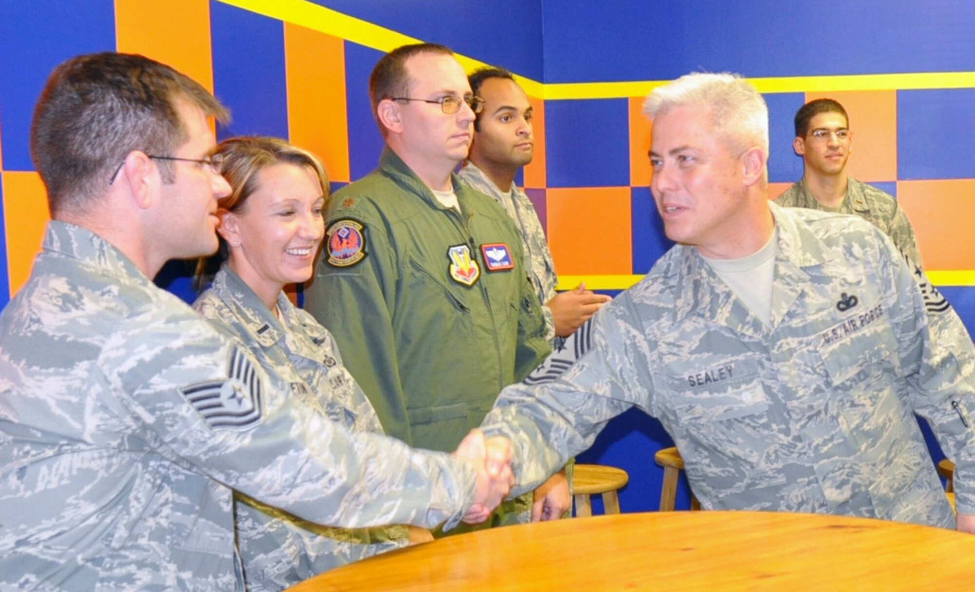 U.S. Air Warfare Center Command Chief CMSgt. Robert Sealey, greets 605th Test and Evaluation Squadron members in the squadron's Heritage Room during a visit to Hurlburt Field, Fla., Dec. 16. Chief Sealey and USAWC Commander Maj. Gen. Bill Hyatt, both new to their positions, received immersion briefings and facility tours of the 505th CCW at Hurlburt Field and 53rd Wing at Eglin Air Force Base, Fla. The center oversees operations of both wings. (U.S. Air Force photo/Bill Dowell)