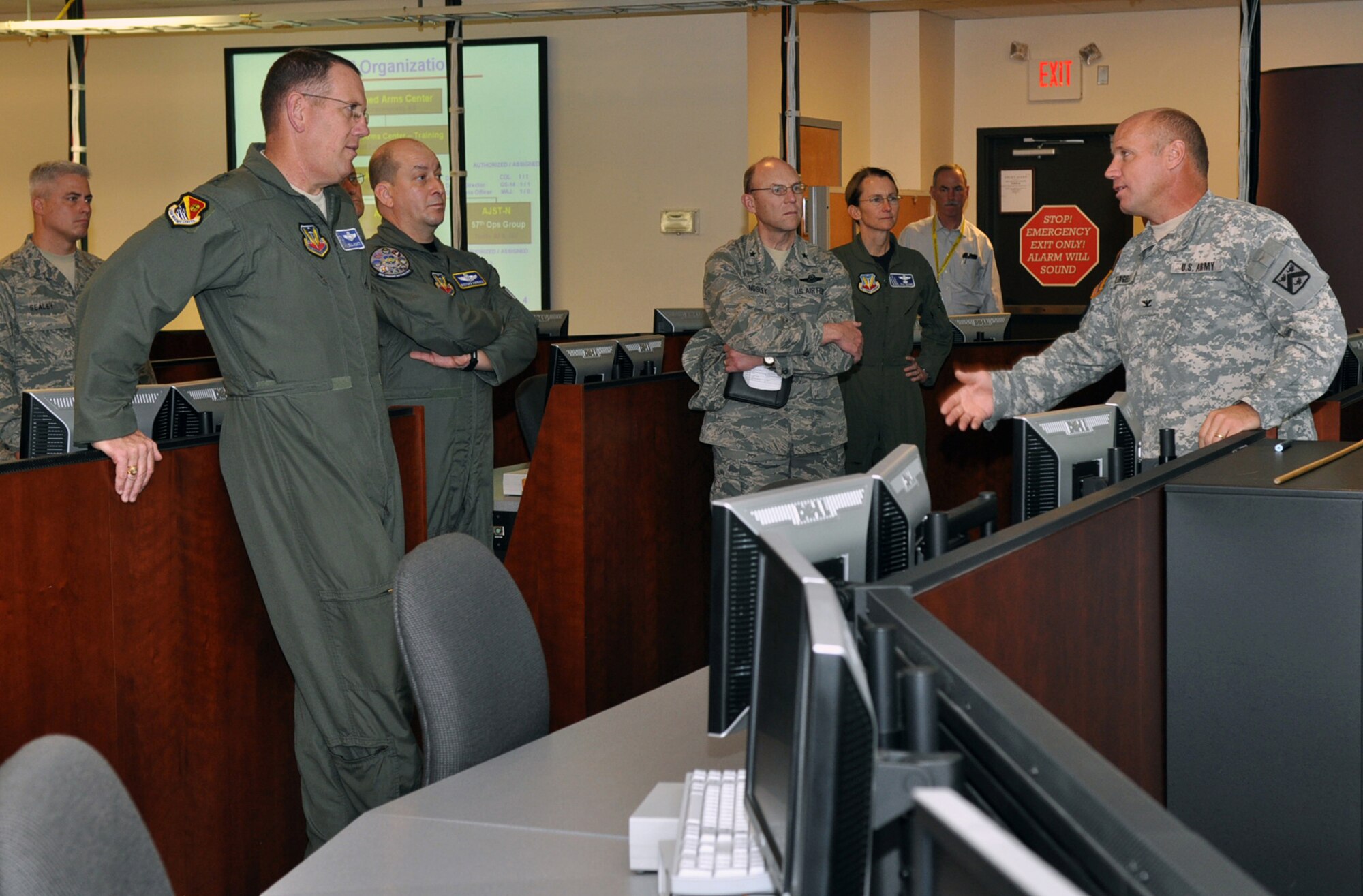 U.S. Army Col. Michael Klingele, Army Joint Support Team director, right, briefs, from left, U.S. Air Warfare Center Command Chief CMSgt. Robert Sealey and Commander Maj. Gen. Bill Hyatt, 505th Command and Control Wing Vice Commander Col. Mustafa Koprucu, 23rd Air Force Commander Brig. Gen. Michael Kingsley and USAFWC Mobilization Assistant Col. Troy Devine about the reconfigurable Joint Air-Ground Command and Control Laboratory Dec. 16 at Hurlburt Field, Fla. General Hyatt and Chief Sealey, both new to their positions, received immersion briefings and facility tours of the 505th CCW at Hurlburt Field and 53rd Wing at Eglin Air Force Base, Fla. The center oversees operations of both wings. (U.S. Air Force photo/Bill Dowell)