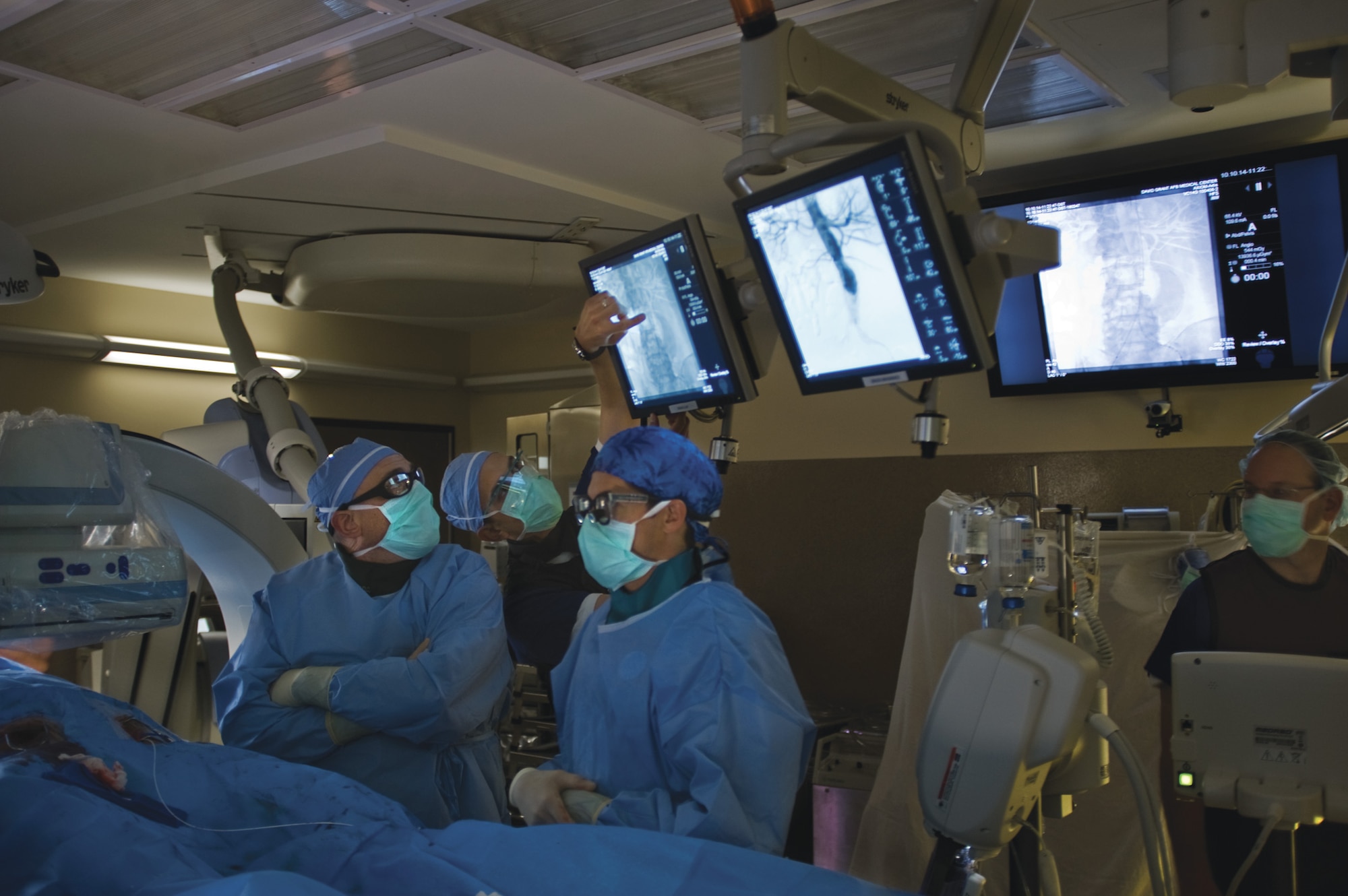 Vascular surgeons at the David Grant USAF Medical Center watch imagery produced by the C-arm of the Artis zeego during a procedure. (U.S. Air Force photo/Tech. Sgt. Bennie J. Davis III)
