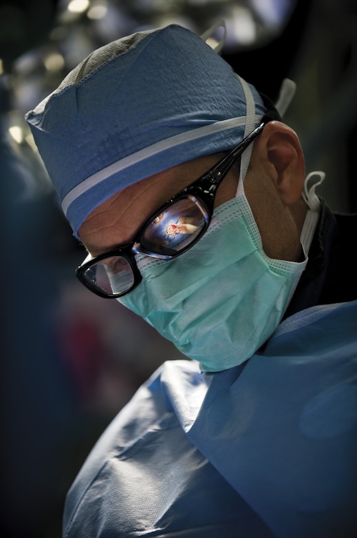 (clockwise from left) Dr. Robert Noll, a vascular surgeon with DGMC, performs an abdominal aortic aneurysm repair procedure in the CVOR.  (U.S. Air Force photo/Tech. Sgt. Bennie J. Davis III)