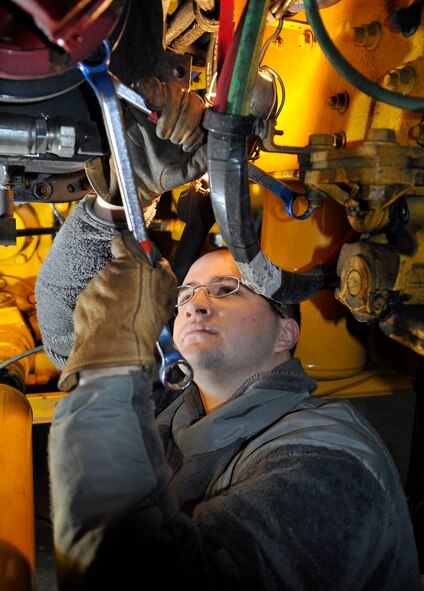 Airman 1st Class Steven Leary inspects shear bolts on a snow blower prior to operation Dec. 16, 2010 at Misawa Air Base, Japan. Shear bolts are designed to break in the event hidden debris in the snow clogs the auger wheel and prevents it from spinning. Airman Leary is a 35th Civil Engineer Squadron pavements and equipment construction technician. (U.S. Air Force photo/Tech. Sgt. Phillip Butterfield/Released) 