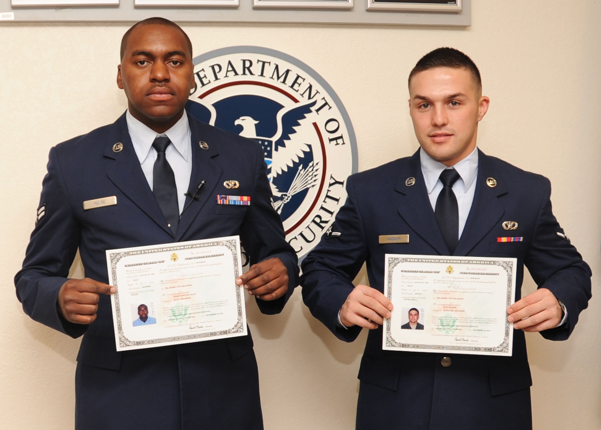OKLAHOMA CITY, Okla. –(L to R) Airman 1st Class Andre Hulse and Airman 1st Class Kyle Hacker, both from the 97th Civil Engineer Squadron, became American citizens when they took the Naturalization Oath of Allegiance in Oklahoma City Dec. 15. Airman Hulse is originally from San Ignacio Belize, and Airman Hacker was born in Johannesburg, South Africa. (U.S. Air Force photo by Airman 1st Class Christopher Toon/97th Air Mobility Wing-Public Affairs)

