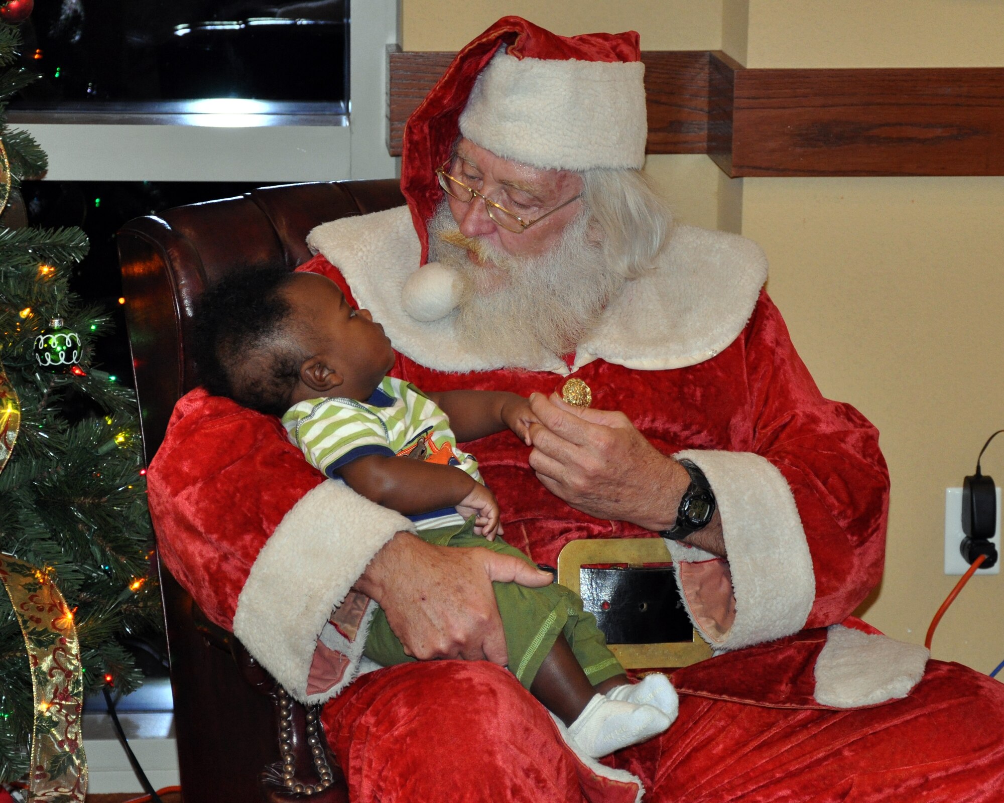 Santa Claus visits with five-month-old Lance, son of a deployed Airman, during the Hearts Apart annual holiday party Dec. 15 at the Soundside Club at Hurlburt Field, Fla. Throughout the year, the program sponsors a series of monthly gatherings for spouses and children of deployed members. (DoD photo by U.S. Airman 1st Class Joe McFadden / RELEASED) 