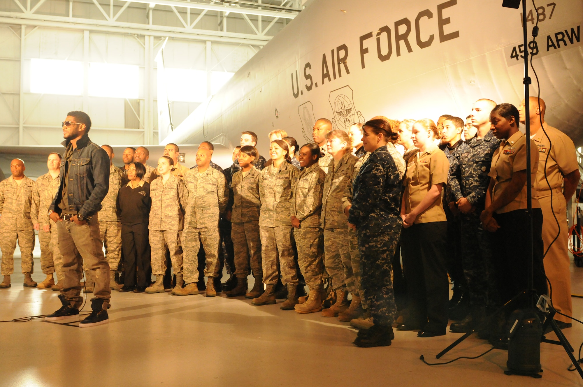 JOINT BASE ANDREWS, Md. -- R&B artist, Usher, records a Public Service Announcement with servcemembers stationed here Dec. 17. Along with recording the PSA, Usher also toured a KC-135 Stratotanker from the 459th Air Refueling Wing and other facilities on base. Later that evening he performed in a concert at the Verizon Center in Washington DC. (U.S. Air Force photo/Tech. Sgt. Steve Lewis)