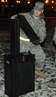 RAF MILDENHALL, England -- Staff Sgt. Andrew Lee, 100th Communications Squadron radio frequency transmission systems supervisor, sets up a public address system for the Christmas Tree Lighting here Dec. 3, 2010.  To ensure audiences can hear the speakers, PA systems are used at commander's calls, military ceremonies and base events. (U.S. Air Force photo/Senior Airman Tabitha M. Lee)