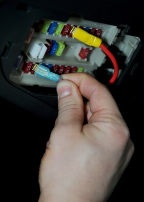 RAF MILDENHALL, England -- Staff Sgt. Andrew Lee, 100th Communications Squadron radio frequency transmission systems supervisor, connects power to a radio during a mobile radio installation here Dec. 1, 2010.  Without these radios many base organizations wouldn't be able to accomplish their mission. (U.S. Air Force photo/Senior Airman Tabitha M. Lee) 