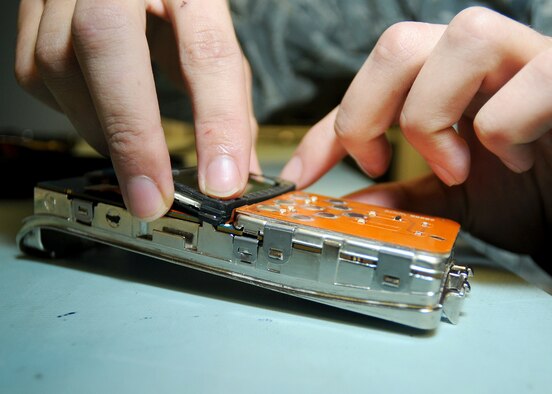 RAF MILDENHALL, England -- Airman 1st Class Nicholas Resley, 100th Communications Squadron Duty Title, assembles land mobile radio here Dec. 1, 2010. Maintaining LMRs is just one part of this shop's mission. (U.S. Air Force photo/Senior Airman Tabitha M. Lee) 
