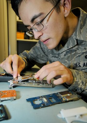 RAF MILDENHALL, England -- Airman 1st Class Nicholas Resley, 100th Communications Squadron radio frequency transmission systems apprentice, assembles a land mobile radio here Dec. 1, 2010.  Maintaining LMRs is just one part of this shop's mission. (U.S. Air Force photo/Senior Airman Tabitha M. Lee)