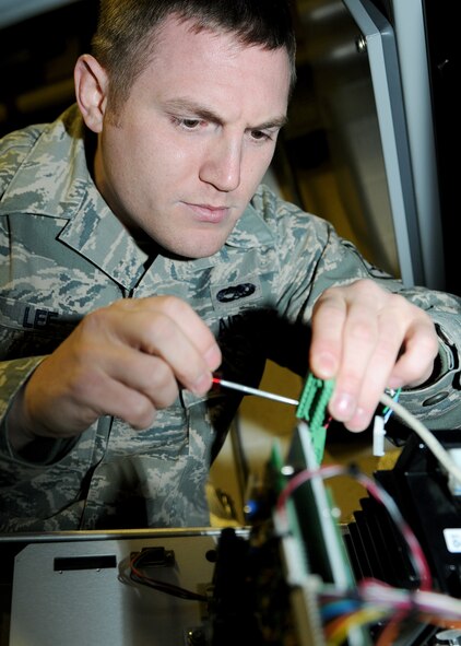 RAF MILDENHALL, England -- Staff Sgt. Andrew Lee, 100th Communications Squadron radio frequency transmission systems supervisor, fixes a node here Dec. 1, 2010.  A node allows the giant voice to receive and emit messages to the speakers attached to it.  (U.S. Air Force photo/Senior Airman Tabitha M. Lee)