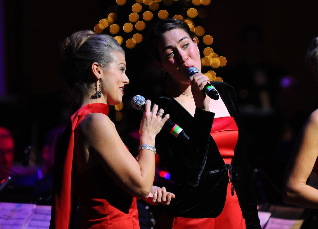 Technical Sgts. Krista Joyce and Victoria Bruyette sing with the Concert Band on an arrangement of 'Snow' from the movie 'White Christmas.'  The performance was part of the USAF Heartland of America Band's annual holiday concert series at the Holland Performing Arts Center in Omaha, Neb.