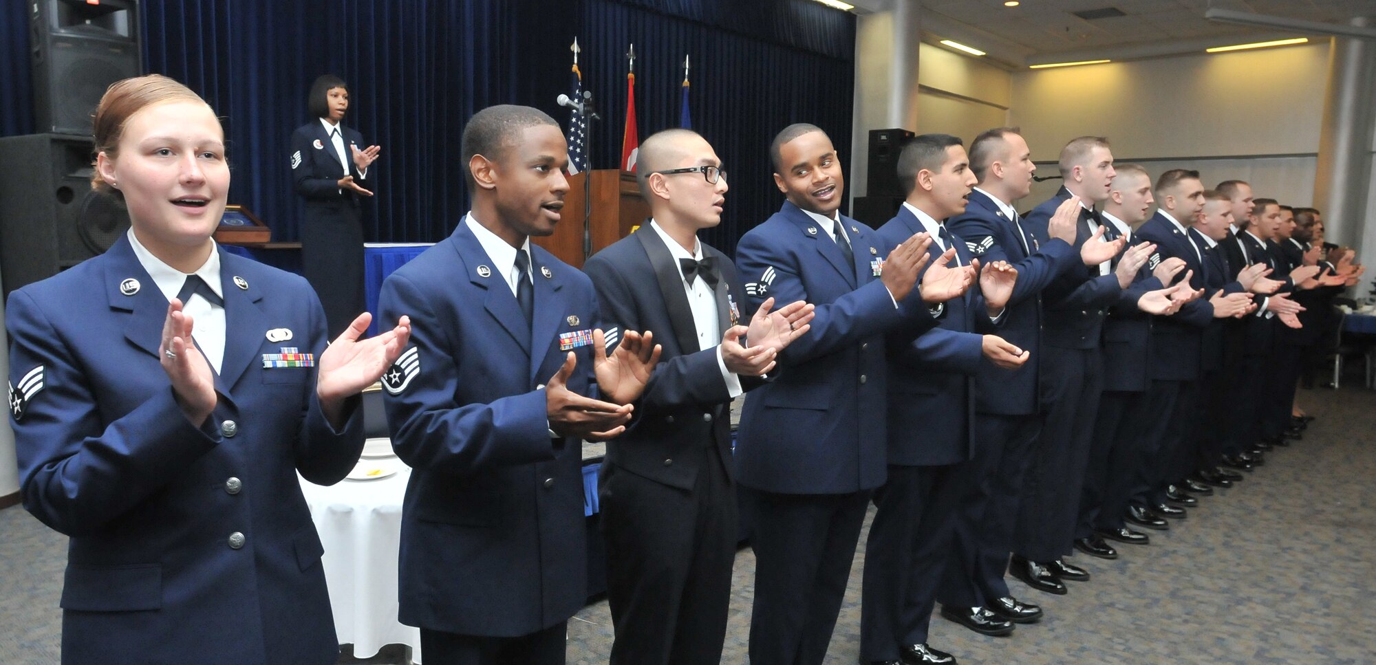 Sixteen graduates from the Airman Leadership School sing the Air Force Song at a graduation ceremony Dec. 3, 2010 at Incirlik Air Base, Turkey. The graduates of class 11-2 were Senior Airmen Berlin Aniciete, Antonia De La Cruz, Todd Graham, Christopher Kosel, and Matthew London, from the 39th Logistics Readiness Squadron;  Senior Airmen Darrell Bowers, Jake Harris, and Trenton Johnson,  from the 39th Security Forces Squadron; Senior Airmen Stanley Graham and Roshaun Williams from the 39th Communications Squadron;  Senior Airman James Owens of the 39th Maintenance Squadron;  Senior Airman Jordan Herrera and Staff Sgt. Matthew Miller, of the 39th Medical Support Squadron;  Senior Airman Zachery LeMaster, from the 39th Maintenance Group;  Senior Airman Ashley Wood, of 39th Air Base Wing; and Staff Sgt. Jermaine Walton, from the 39th Comptroller Squadron. (U.S. Air Force photo by Staff Sgt. Alex Montes)
