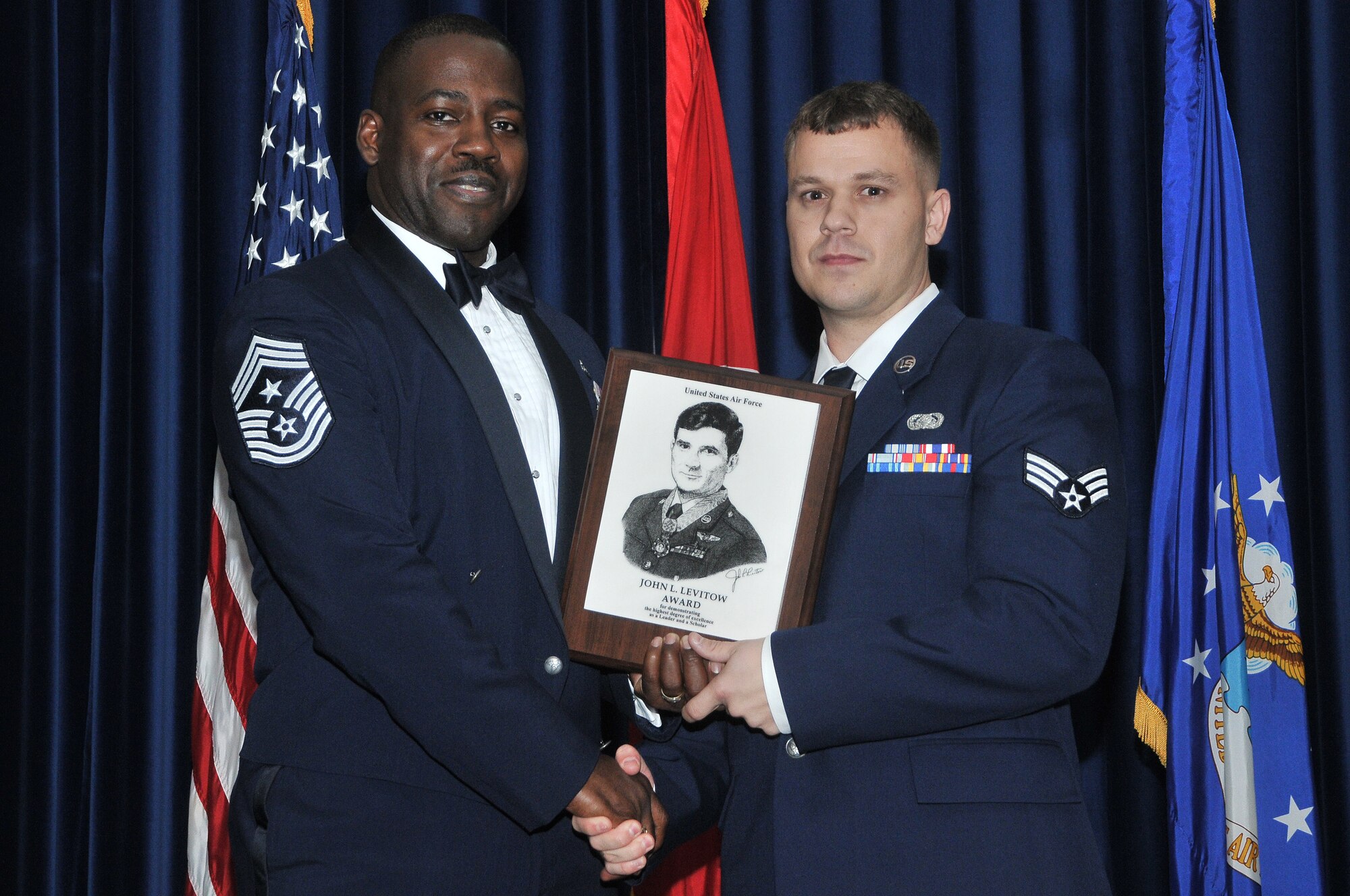 Chief Master Sgt. Marcus Snoddy, the 39th Air Base Wing command chief, awards the John L. Levitow Award to Senior Airman Stanley Graham, of the 39th Communications Squadron, during the Airman Leadership School graduation for class 11-2 at the consolidated club Dec. 3, 2010 at Incirlik Air Base, Turkey. The Levitow Award is the pinnacle achievement for enlisted Airmen enrolled in professional military education in the U.S. Air Force. It is awarded to the top graduate at each level of PME: ALS, NCO Academy and Senior NCO Academy. There is only one Levitow Award given in each class. (U.S. Air Force photo by Staff Sgt. Alex Montes)