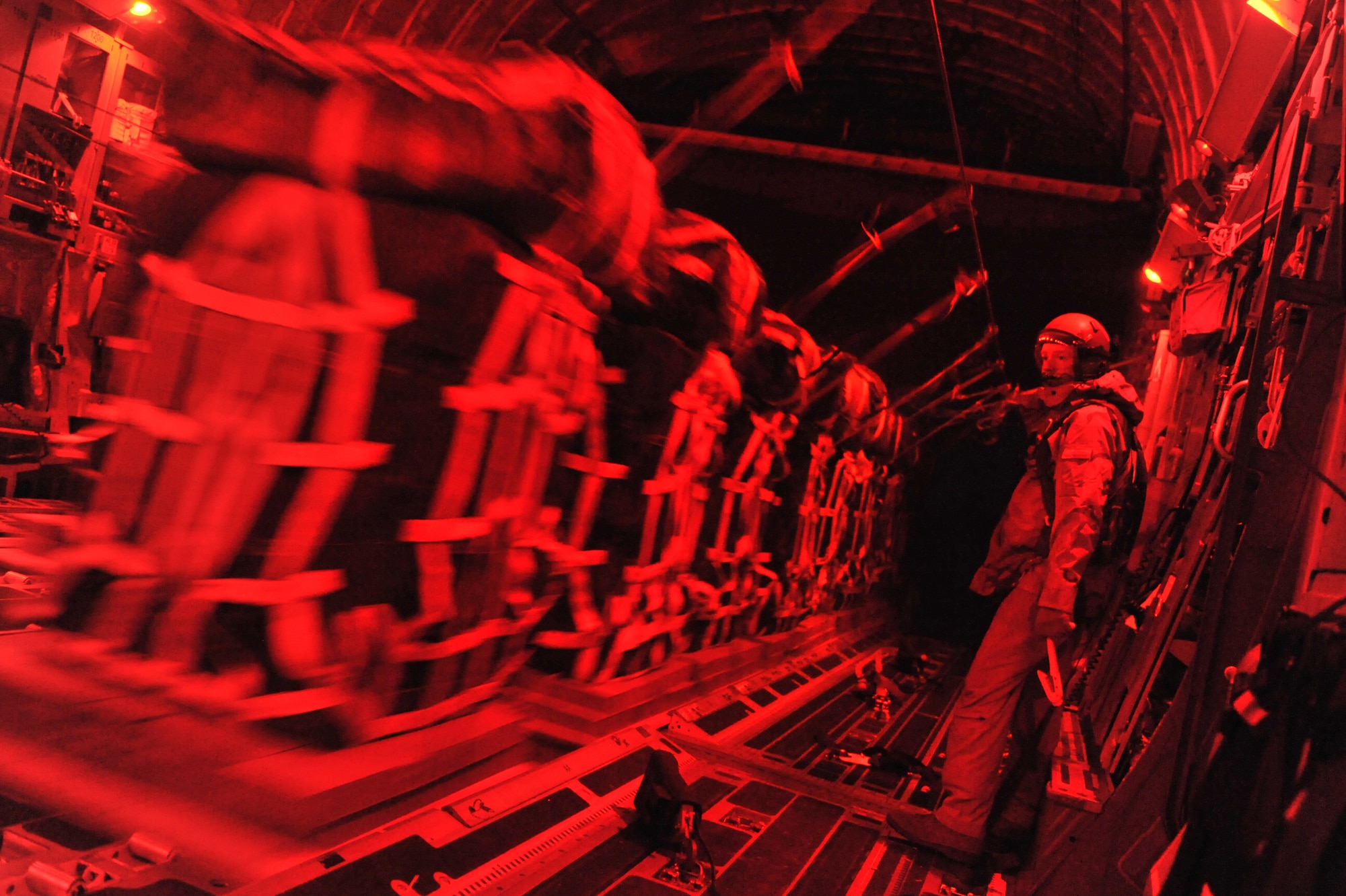 Master Sgt. Michael Patton, 816th Expeditionary Airlift
Squadron, oversees an airdrop of food and water from an Air Force C-17
Globemaster III to a foward operating base in Afghanistan, Dec. 19, 2010.
Airmen routinely deliver and distribute supplies to FOBs and other isolated
locations faster than conventional convoys. Sergeant Patton is a native of
The Dalles, Ore., deployed from McChord Air Force Base, Wash. (U.S. Air Force Photo/Senior Airman Sheila deVera)

