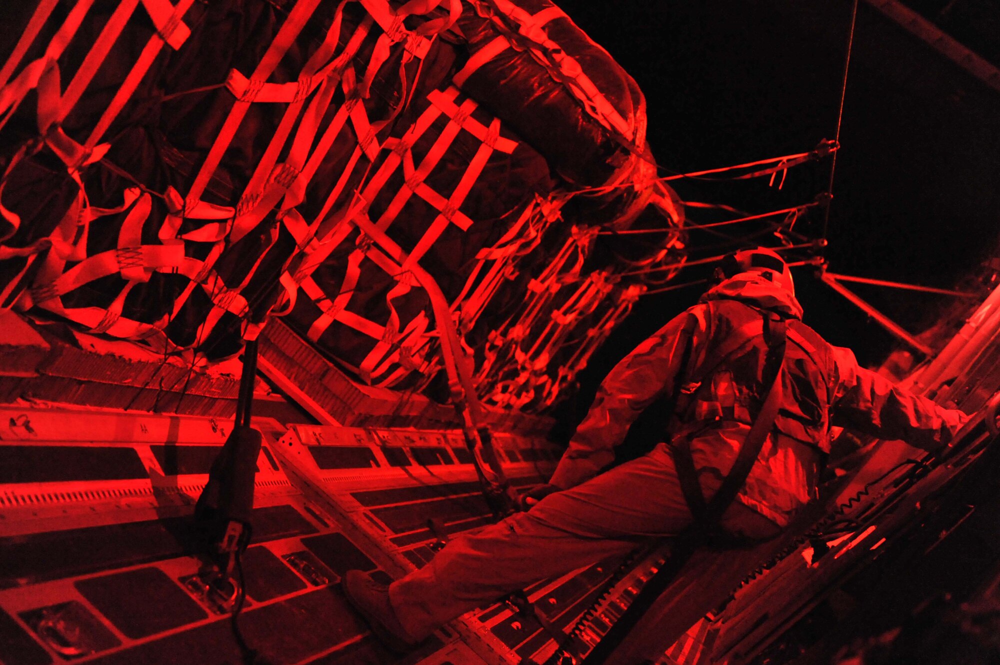 Master Sgt. Michael Patton, 816th Expeditionary Airlift
Squadron, oversees an airdrop of food and water from an Air Force C-17
Globemaster III to a foward operating base in Afghanistan, Dec. 19, 2010.
Airmen routinely deliver and distribute supplies to FOBs and other isolated
locations faster than conventional convoys. Sergeant Patton is a native of
The Dalles, Ore., deployed from McChord Air Force Base, Wash. (U.S. Air Force Photo/Senior Airman Sheila deVera)

