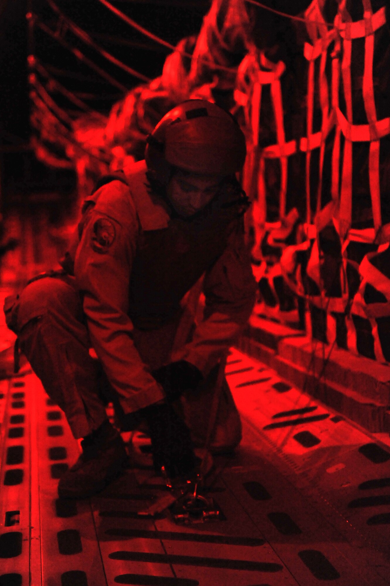 Staff Sgt. Robert Clark, 816th Expeditionary Airlift Squadron, removes the strap before airdropping food and water from an Air Force C-17
Globemaster III to a foward operating base in Afghanistan, Dec. 19, 2010.
Airmen routinely deliver and distribute supplies to FOBs and other isolated
locations faster than conventional convoys. Sergeant Clark is a native from Temecula Valley, Calif., deployed from McChord Air Force Base, Wash. (U.S. Air Force Photo/ Senior Airman Sheila deVera)

