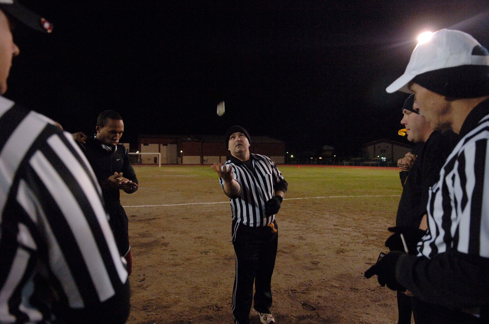 Team captains from the 39th Security Forces Squadron and the 39th Maintenance Squadron meet for the coin toss during the 2010 Intramural Flag Football Championship game Dec. 13, at Incirlik Air Base, Turkey. SFS won the game 34-6. (U.S. Air Force photo by Senior Airman Ashley Wood/Released)