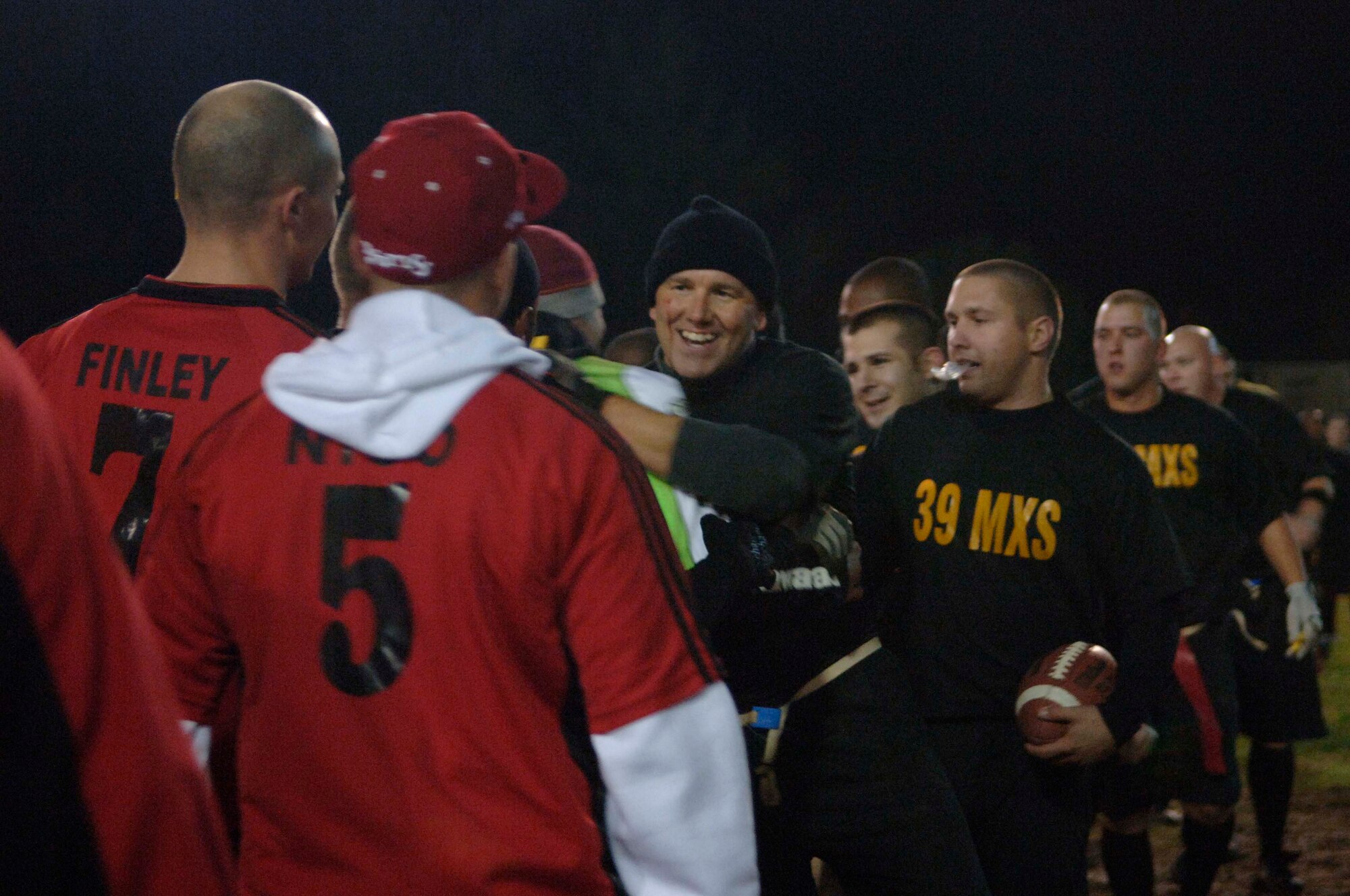 Players from the 39th Maintenance Squadron and the 39th Security Forces Squadron congratulate each other after the 2010 Intramural Flag Football Championship game Dec. 13, at Incirlik Air Base, Turkey. SFS won the game 34-6.  (U.S. Air Force photo by Senior Airman Ashley Wood/Released)