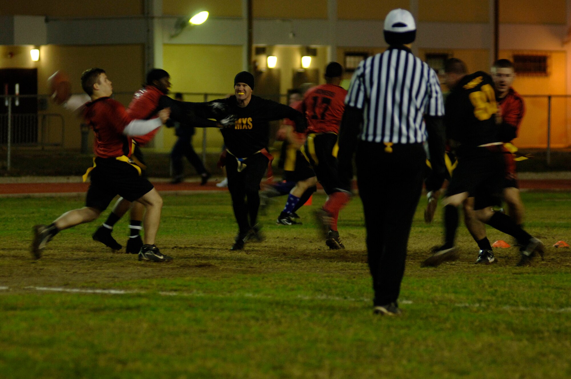 39th Security Forces Squadron quarterback, Matthew Rowe, drops back for a pass against the 39th Maintenance Squadron during the 2010 Intramural Flag Football Championship game Dec. 13, at Incirlik Air Base, Turkey. SFS won the game 34-6. (U.S. Air Force photo by Senior Airman Ashley Wood/Released)