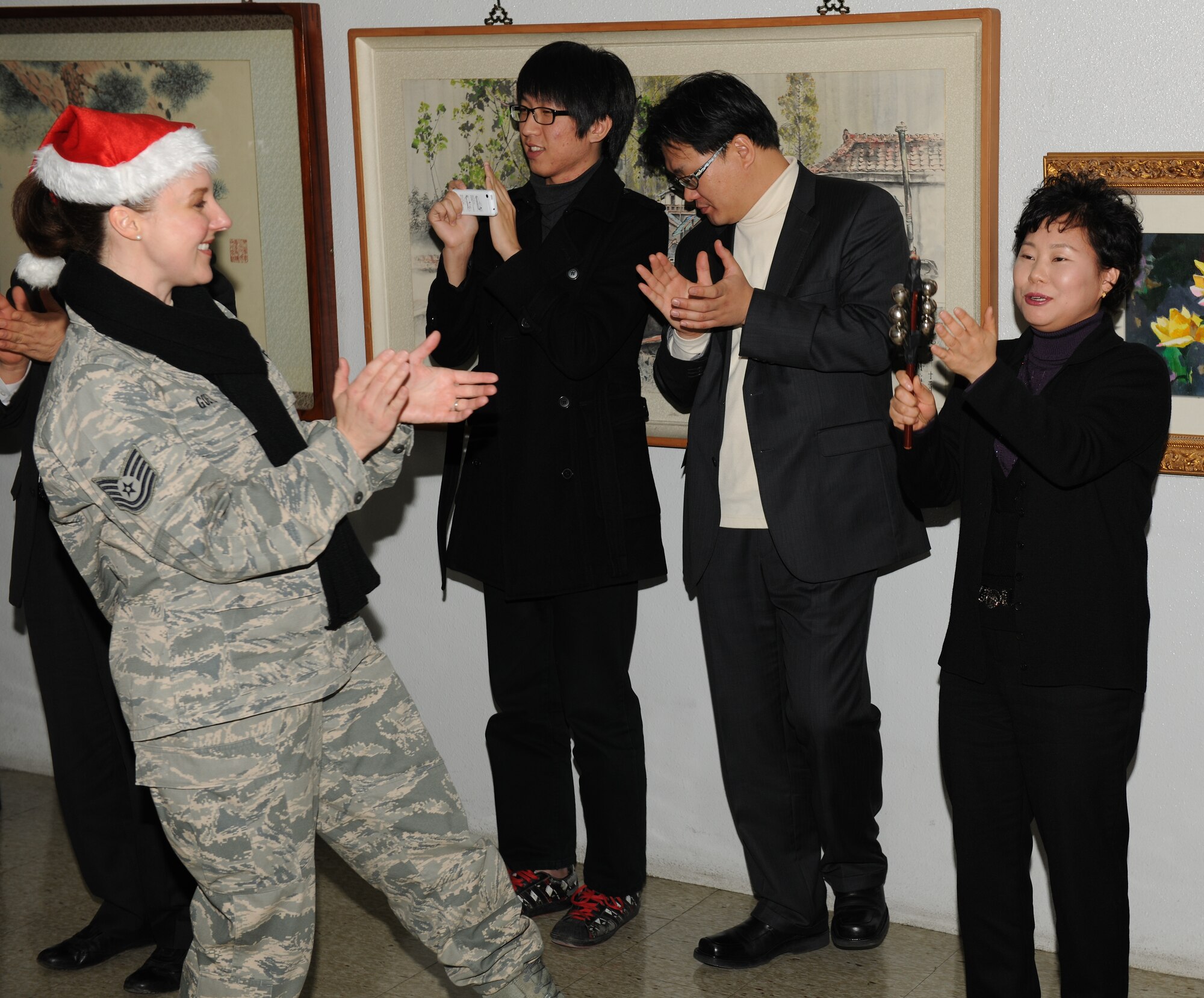 KUNSAN AIR BASE, Republic of Korea -- Tech. Sgt. Paula Goetz, U.S. Air Force Band of the Pacific-Asia Pacific Trends vocalist, interacts with citizens at Gunsan City Hall during a performance Dec. 17. The group performed for the Wolf Pack and citizens at the Gunsan City Hall to lift holiday spirits and promote friendship between the countries. (U.S. Air Force photo/Master Sgt. Jason Wilkerson)
