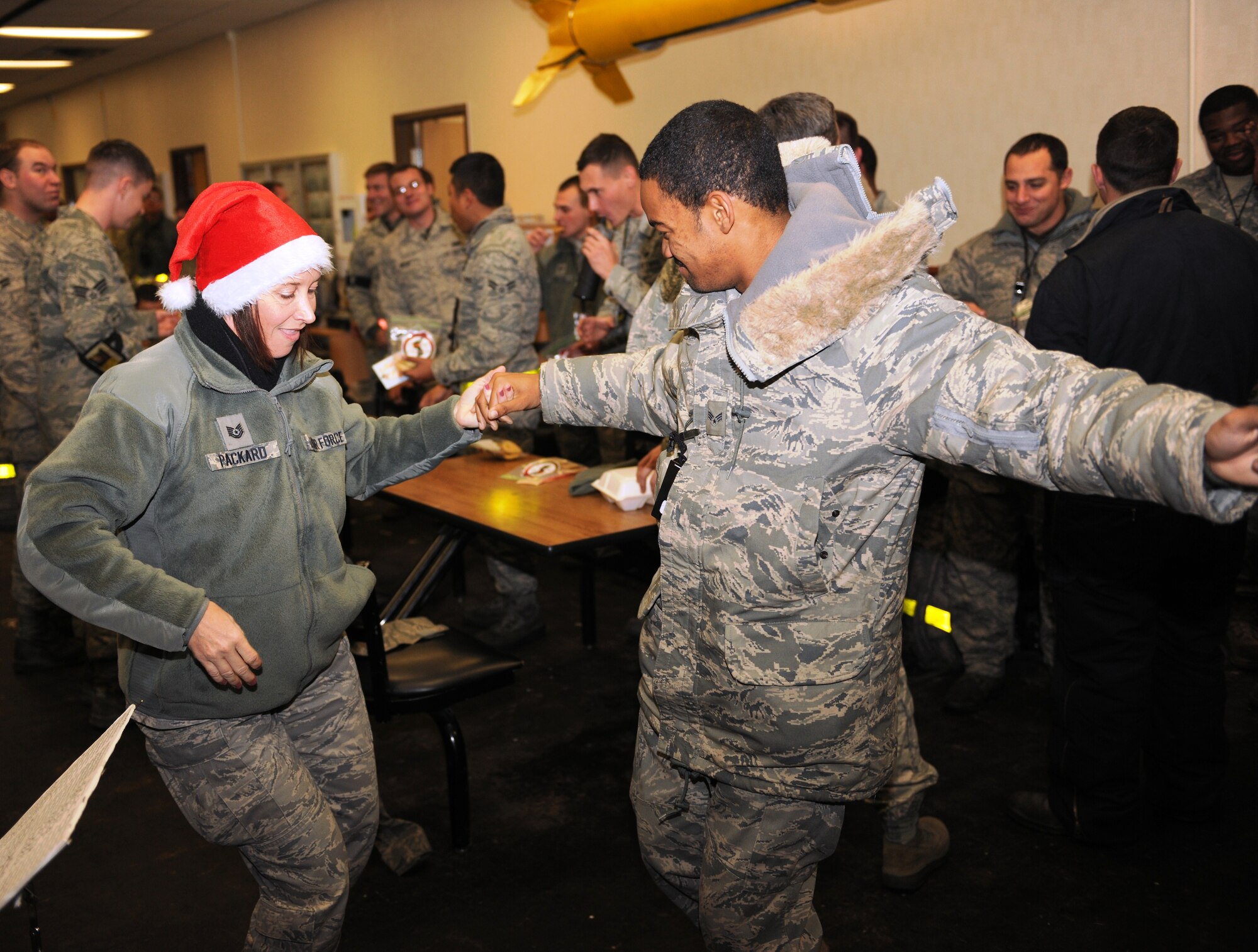 KUNSAN AIR BASE, Republic of Korea -- Tech. Sgt. Rebecca Packard, U.S. Air Force Band of the Pacific-Asia Pacific Trends vocalist, dances with Senior Airman Ryan Cole, 80th Aircraft Maintenance Unit crew chief, Dec. 17. The group performed for the Wolf Pack and citizens at the Gunsan City Hall to lift holiday spirits and promote friendship between the countries. (U.S. Air Force photo/Senior Airman Ciara Wymbs)