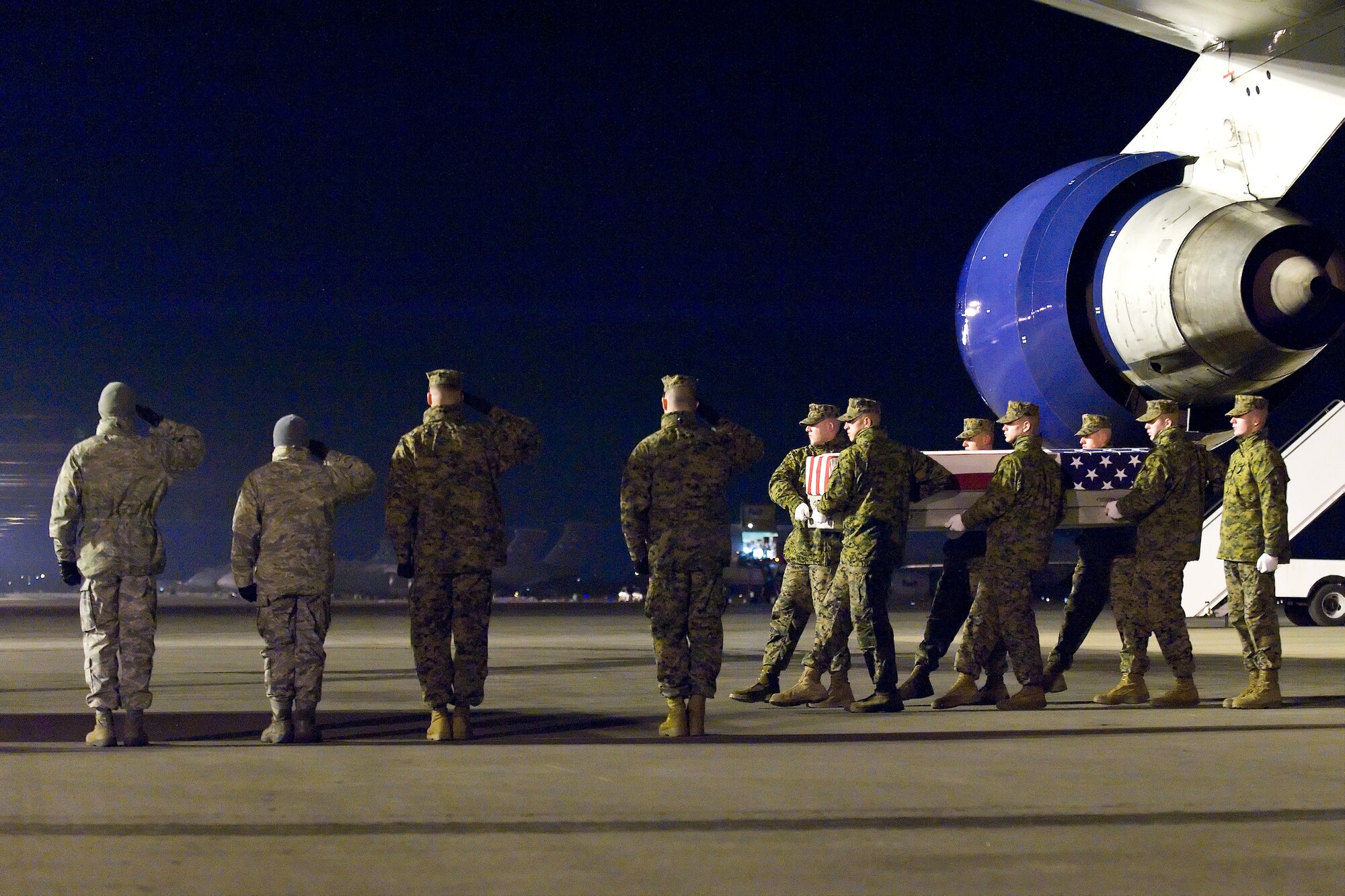 A U.S. Marine Corps carry team transfers the remains of Marine Cpl. Eric M. Torbert Jr., of Lancaster, Pa., at Dover Air Force Base, Del., Dec. 20, 2010. Torbert was assigned to the 1st Combat Engineer Battalion, 1st Marine Division, I Marine Expeditionary Force, Camp Pendleton, Calif.  (U.S. Air Force photo/Roland Balik)
